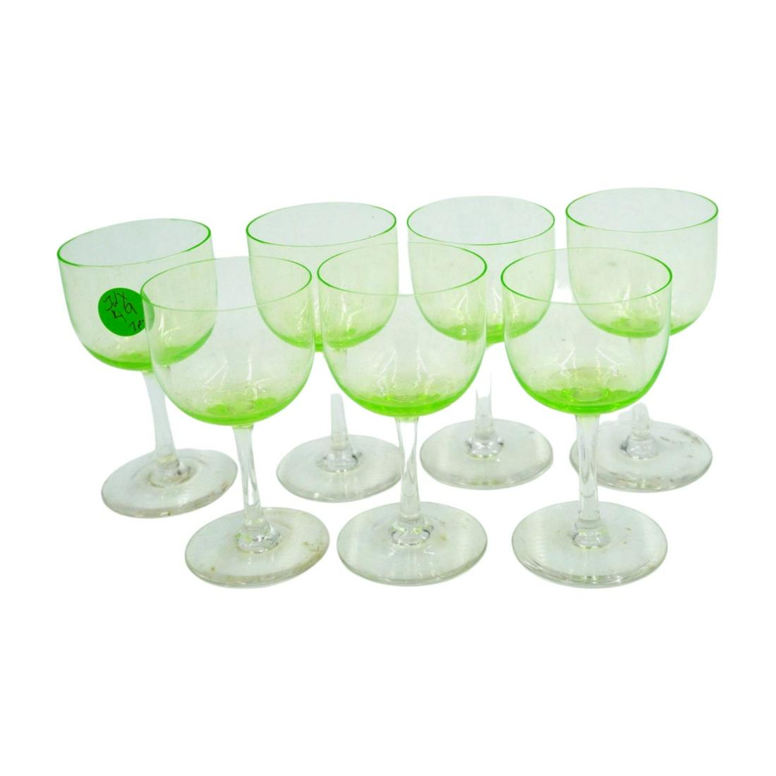7 VINTAGE VASELINE WINE GLASSES: 7 Vintage Vaseline Wine Glasses with Clear Stems. Strong glow. Each 2 1/4"x 4". Weight to ship 1 pd. PROVENANCE: A Charleston SC Private Estate