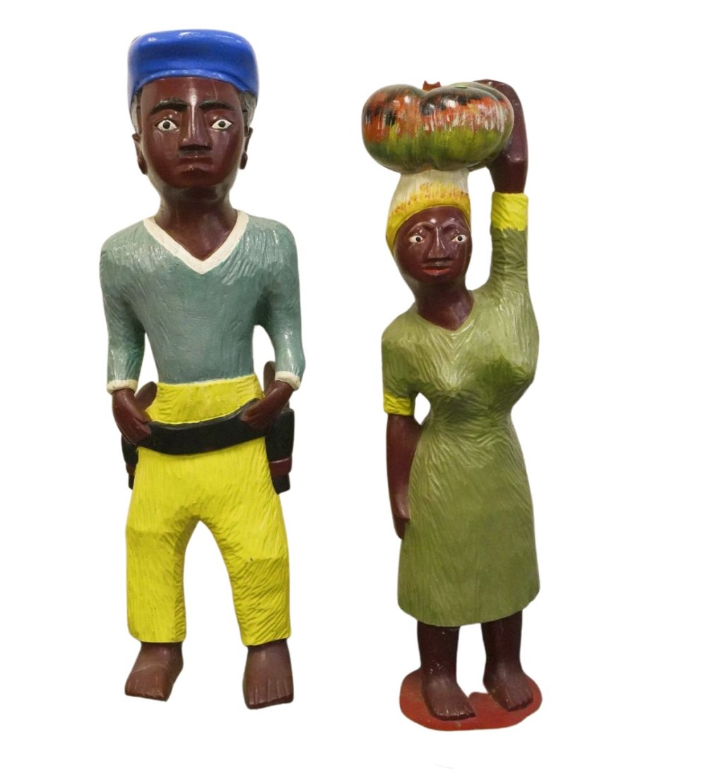 PAIR VINTAGE LARGE COLON FIGURES IVORY COAST: Pair of Vintage Large Carved Wood Colon Statues made in the Ivory Coast by the Baoule people. The gent with a gun in a hip holster 43". The woman with a large gourd on her head 40". Combined weight 70