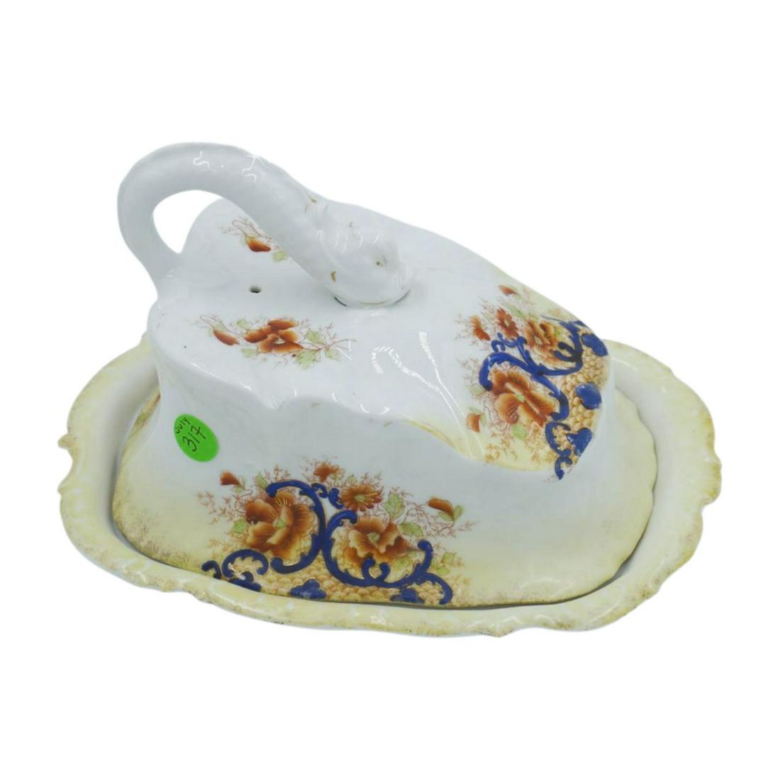 ANTIQUE BLUE & ORANGE DOLPHIN CHEESE DISH: Beautiful unmarked 19th century english ironstone cheese dish patterned with blue and orange designs with dolphin handle. This piece measures 10" in width and 6" in height. Weight is 2 lbs and 3 oz.