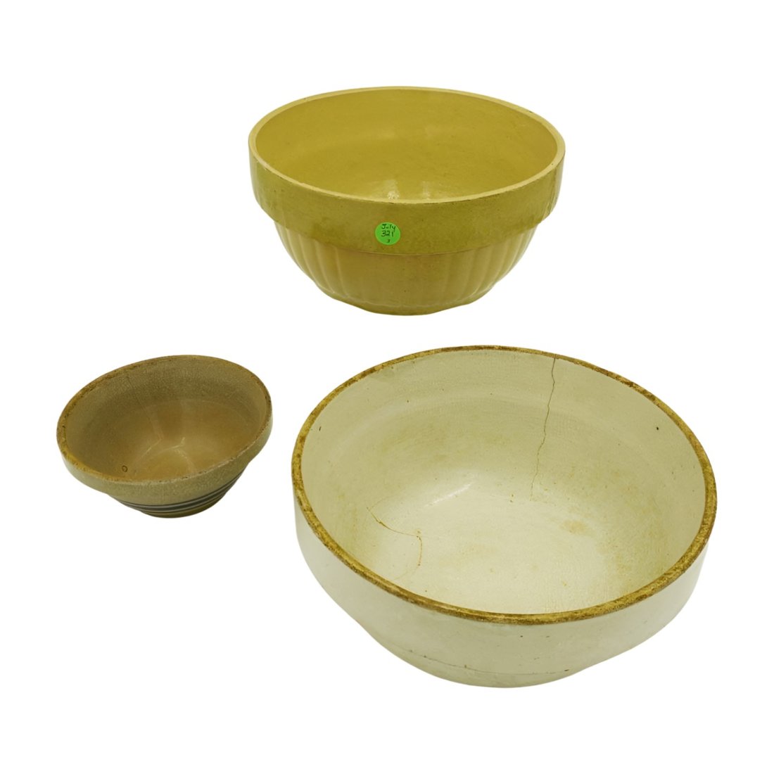 3 ANTIQUE YELLOW WARE MIXING BOWLS: 3 Antique Yellow Ware Mixing Bowls. Largest 10"x10"x5". Medium, with hairline 10.50"x10.50"x4.75". Small with hairline 6.5"x6.5"x3". Weight 10 pds.