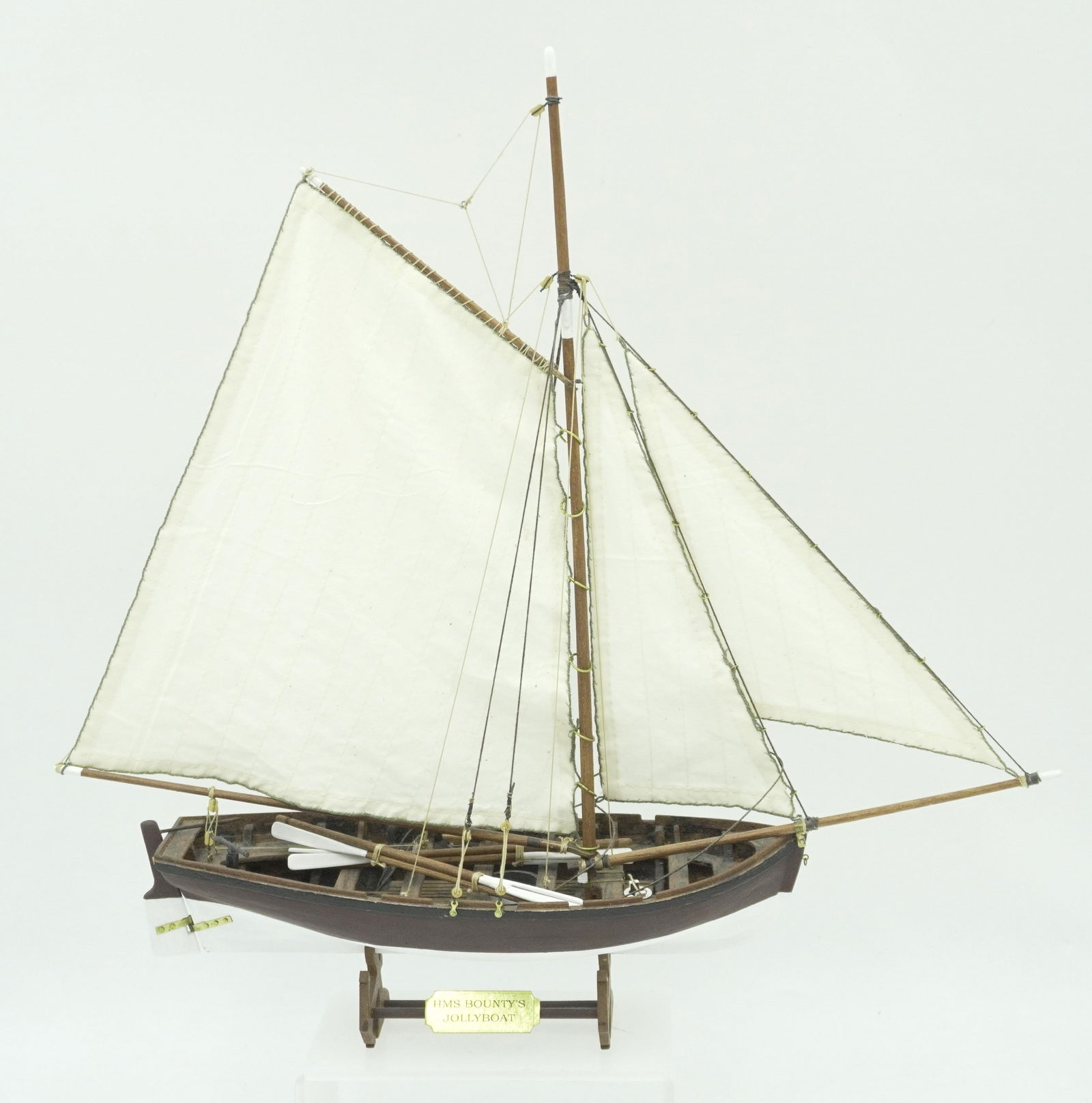 HMS BOUNTY'S JOLLYBOAT SHIP MODEL: Vintage HMS Bounty's Jollyboat Ship Model. Measures 14"x4"x15.5". Weight 15 oz