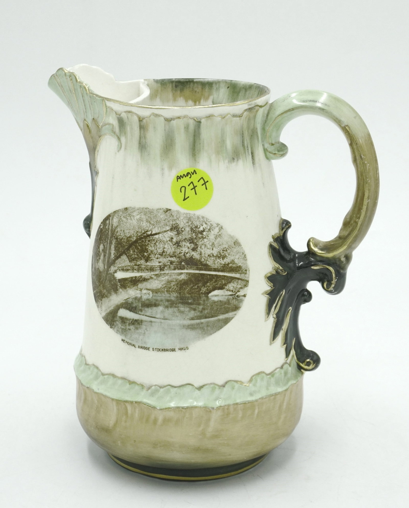 ANTIQUE SOUVENIR MEMORIAL BRIDGE STOCKBRIDGE MASSACHUSETTS PITCHER: Antique pitcher featuring beautiful gilt details and image of Memorial Bridge in Stockbridge, Massachusetts. Marked Hampshire on the bottom. Measures 7.5" tall and 6" at its widest point. Lot weight i