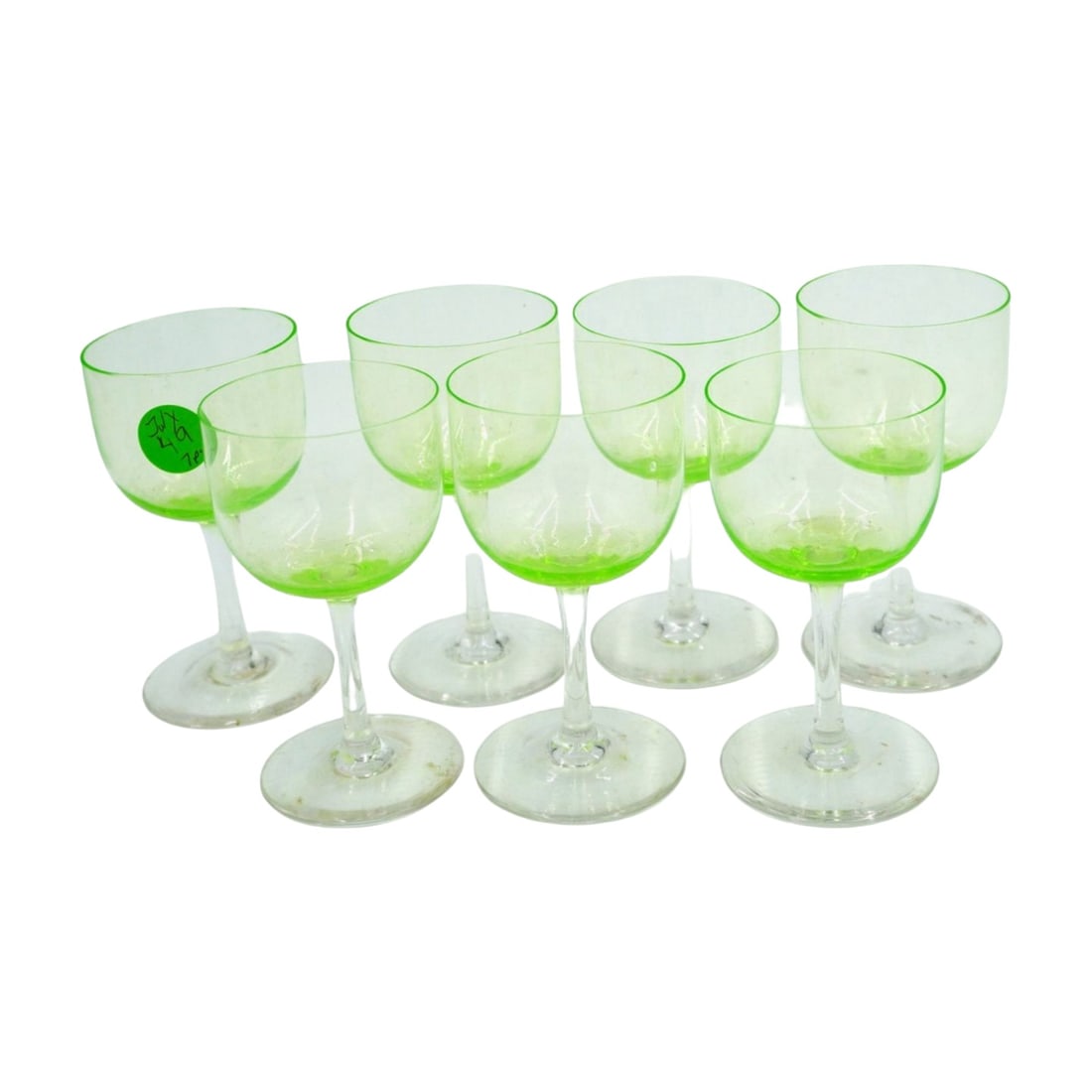 7 VINTAGE VASELINE WINE GLASSES: 7 Vintage Vaseline Wine Glasses with Clear Stems. Strong glow. Each 2 1/4"x 4". Weight to ship 1 pd. PROVENANCE: A Charleston SC Private Estate