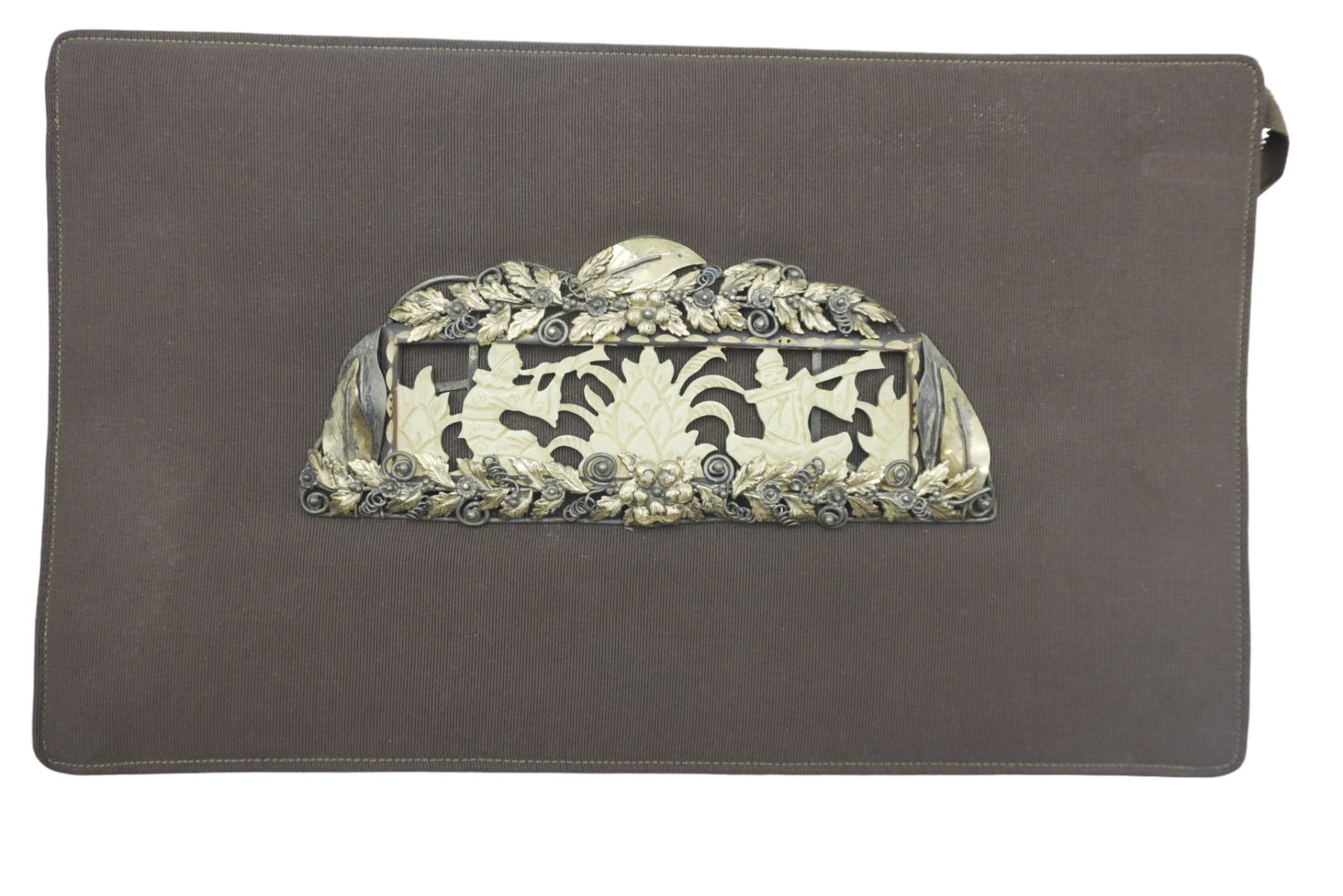 ANTON MORITZ ART DECO CLUTCH: Anton Moritz Art Deco Clutch. Silk with front plaque of carved bone Asian musicians surrounded by a frame of silver and gilt foliage. Plaque 7.25"x3". Measures 13"x8"x2". Weight 1 lb
