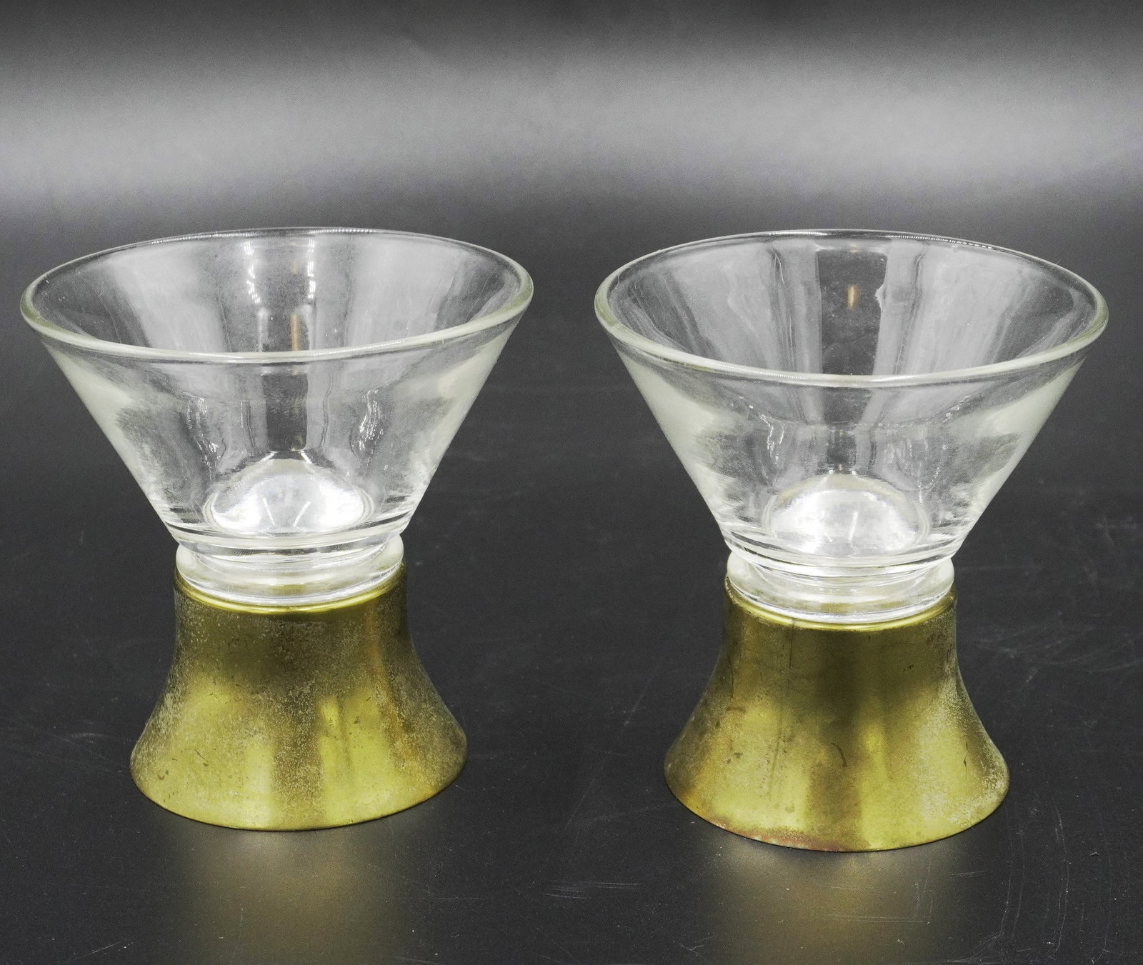 2 MCM NUDIE COCKTAIL GLASSES BRASS BASE: 2 Scarce Mid Century Modern Nudie Cocktail Glasses. Set in gilded brass bases, the nudes are inside the bases and enlarged when liquid is added. The cocktail glasses appear normal until you go to take