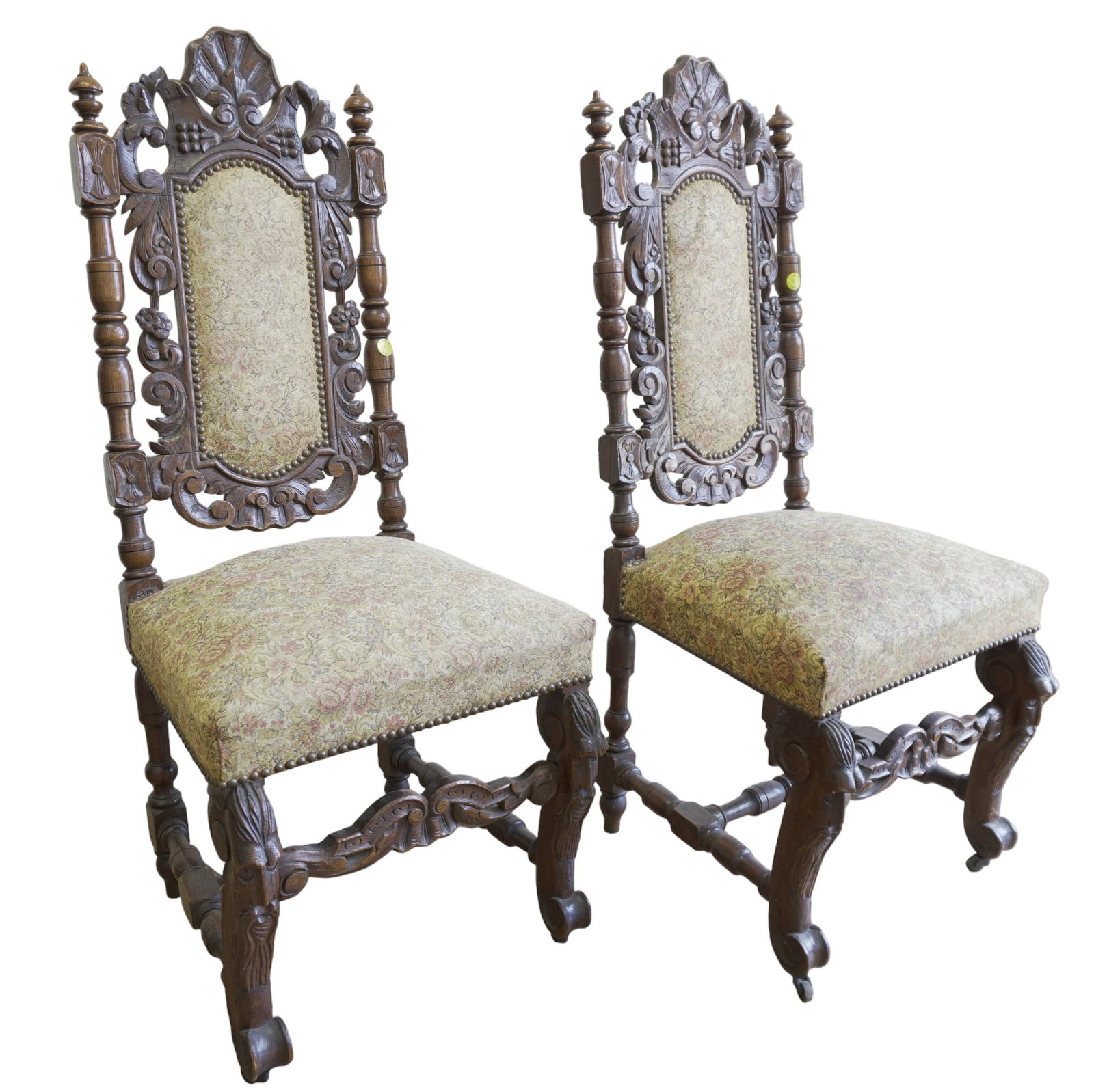 PAIR 19TH C FINELY CARVED RENAISSANCE CHAIRS: Pair of 19th c Richly Carved Renaissance style Chairs. Brocade Tapestry Upholstery on casters. Good condition. 19"x18"x44"