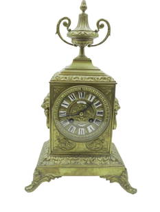 19th CENTURY NAPOLEON III BRONZE CLOCK NEW YORK: 19th Century Gilded Bronze / Brass Napoleon III Clock with enameled numeral dial, glass back, urn top and lion mask sides face marked Oxley, Giddings & Enos, New York. With key. The clock was running