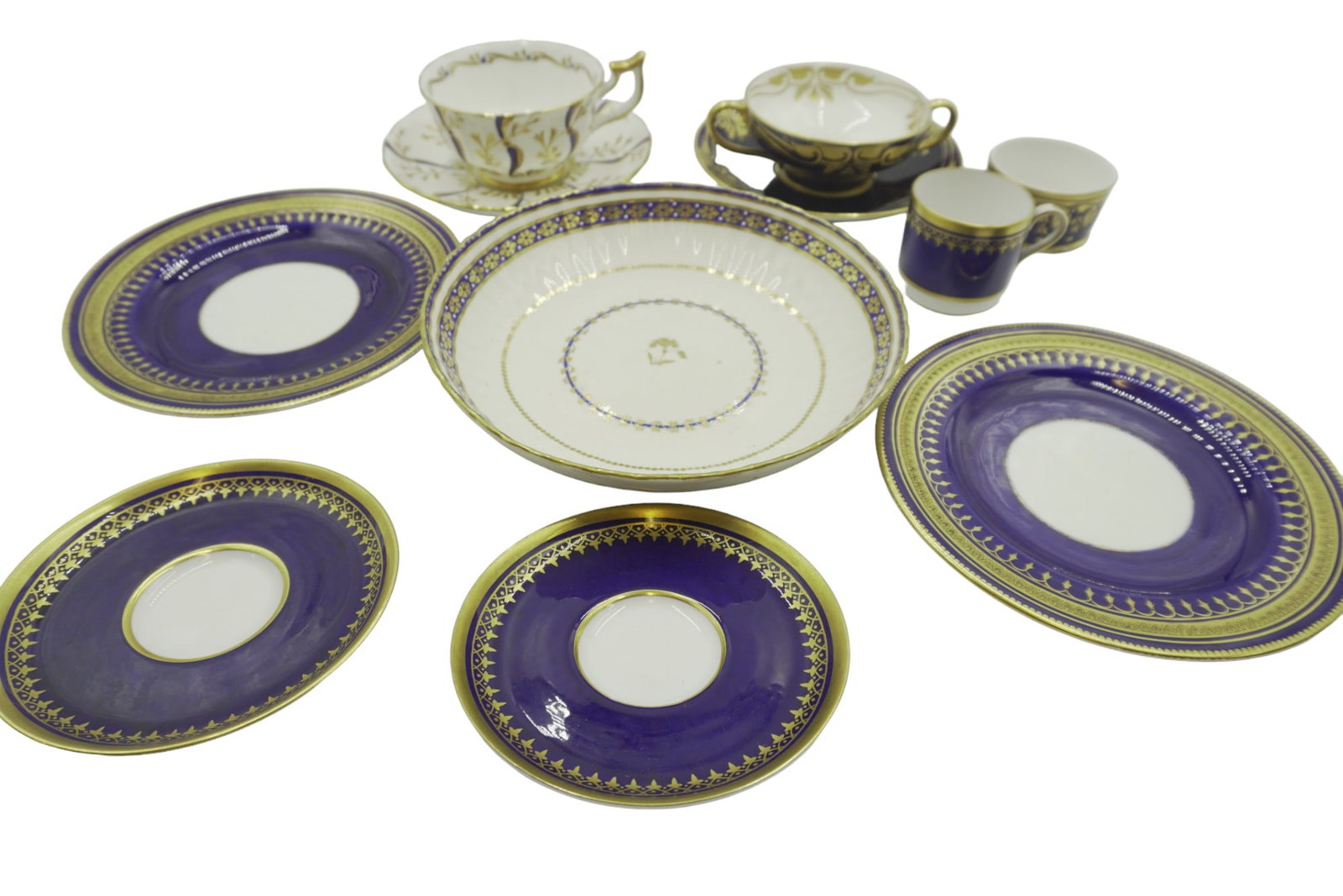 LOT ANTIQUE COBALT BLUE AND GOLD GILT CHINA - 11 PIECES: Lot of antique and vintage cobalt blue and gold gilt china. 1. Doulton Burslem bone china two handled cup and saucer. 2. Spode Copeland, 2 saucers, 2 small saucers, 1 demitasse. 3. Royal Chelsea one c