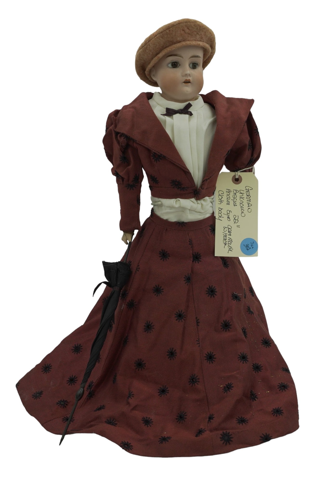 ANTIQUE GERMAN PORCELAIN BISQUE DOLL 21": Antique German Bisque Doll with Cloth Body. Brown glass eyes, open mouth with teeth. No hair, beret. Maker unknown marked Germany on the back. Measures 21". Weight 2 lbs.