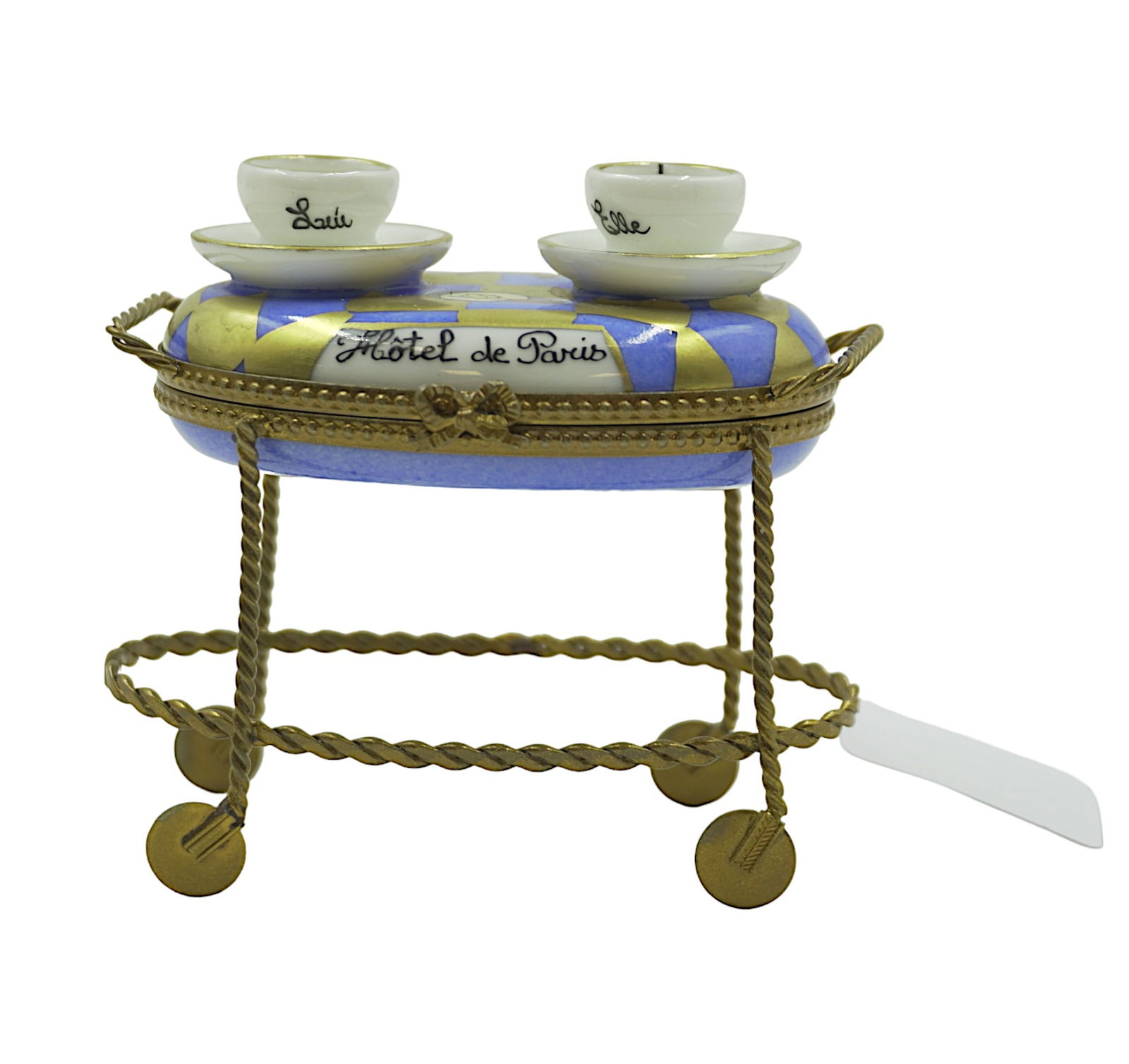 HOTEL DE PARIS SERVING CART LIMOGES BOX: Hotel de Paris serving cart Limoges box. Hand Painted porcelain from France. Featuring 3D teacups, bow clasp, and metal leg/wheel details. Signed Limoges France Peint Main and initials. Measures 3" ta