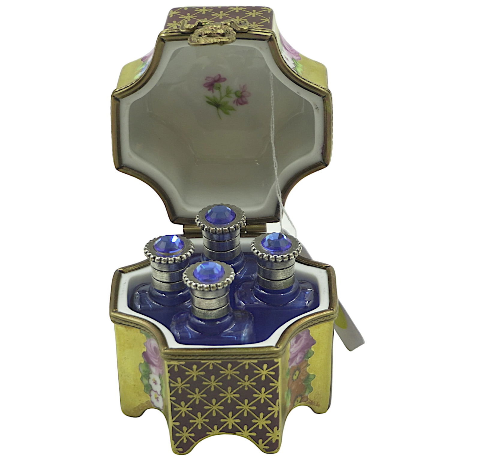 LIMOGES PERFUME HOLDER BOX: Limoges perfume holder box. Hand Painted porcelain from France. Featuring a painted crane, floral design, gold accent, and wreath clasp. Inside has 4 blue perfume holders with gem top and rubber stopp