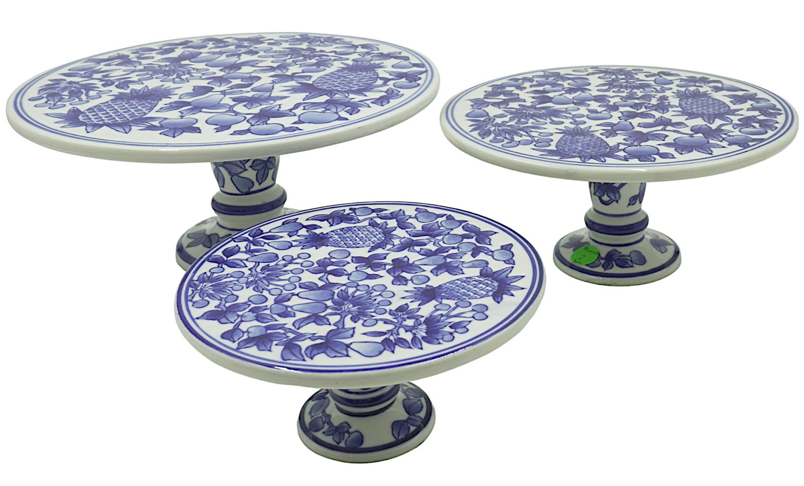 3 BLUE & WHITE CAKE STANDS PINEAPPLES: Three Blue & White Cake Stands with Pineapple and Fruit Motif. Excellent condition. Larger 11"x11"x5.25". Middle 9"x9"x4.25", Small 6.75"x6.75"x3". Weight on all 7 lbs