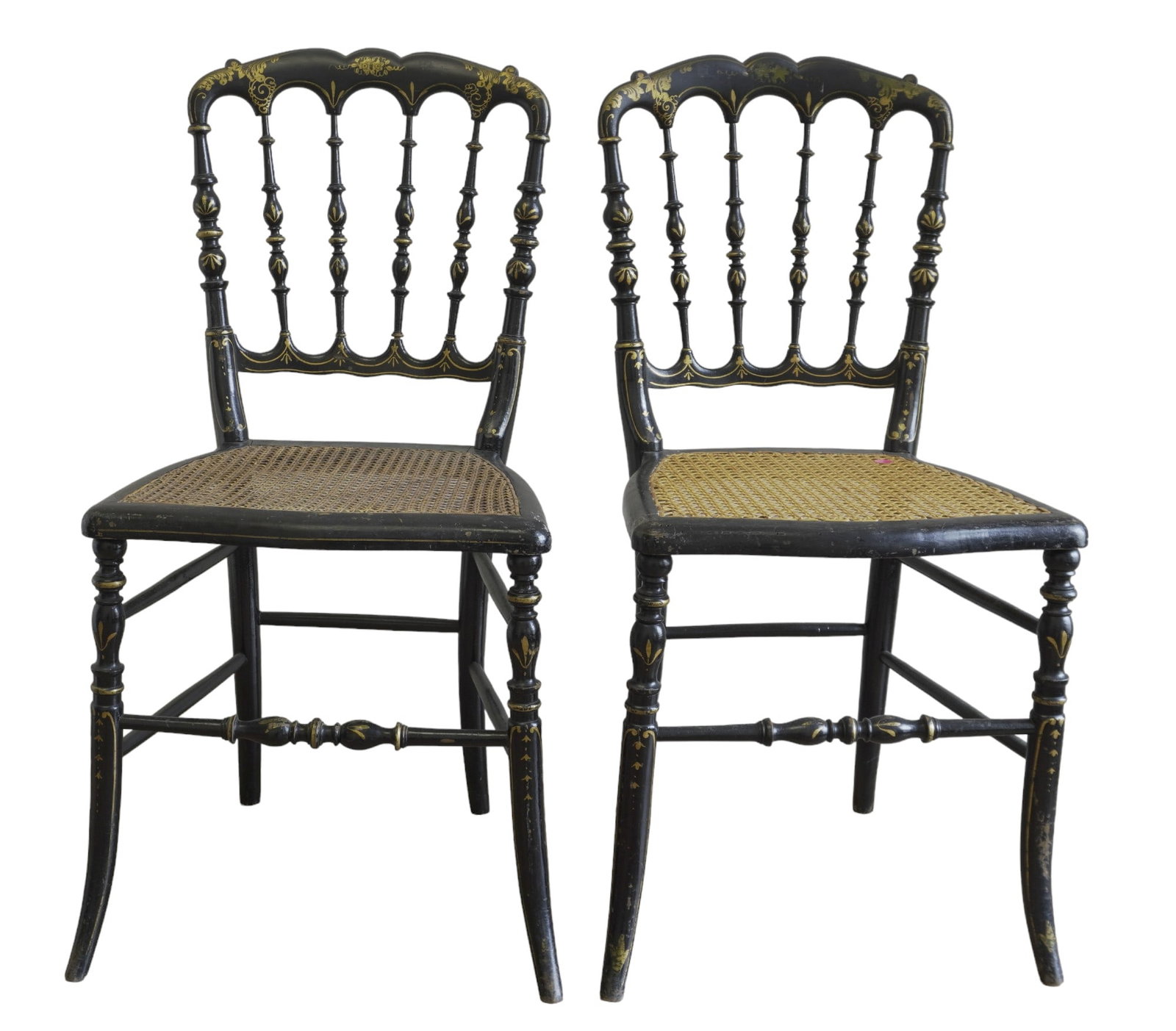 PAIR ANTIQUE EBONIZED FRENCH SIDE CHAIRS: Pair of Antique Ebonized Napoleon III French Side Chairs c. 1850. Carved wood, cane seated with intricate gold hand painted details. 13.5"x14.5"x33.25".