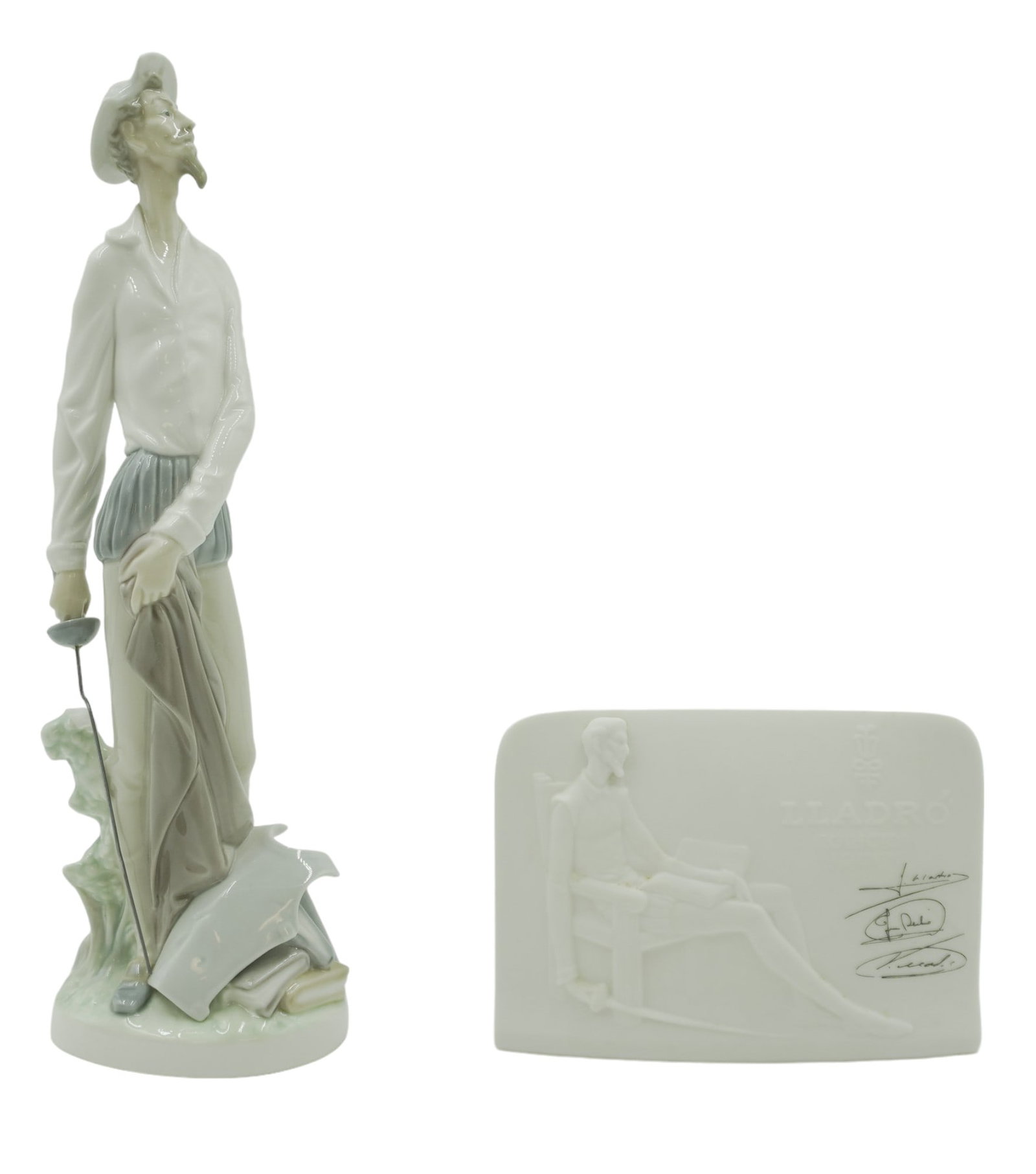 VINTAGE LLADRO DON QUIXOTE FIGURINE AND SIGNED PLAQUE: Vintage Lladro Don Quixote figurine and signed collectors society plaque. Figurine measures about 12" tall, 3.5" long and 2.5" in depth. Plaque measures about 4.25" tall, 6" long, and 2.25" in depth. 