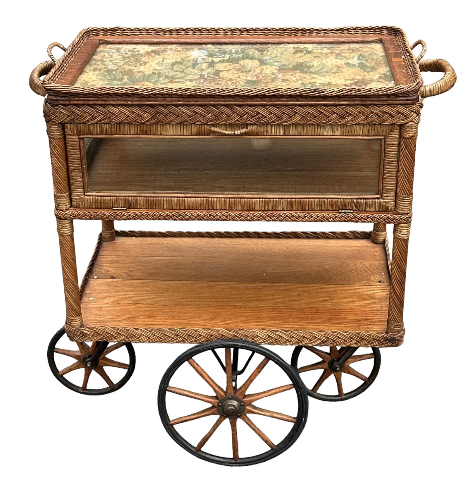 HEYWOOD WAKEFIELD WICKER SERVING CART: Heywood-Wakefield Wicker Tea / Bar Cart. Removable glass tray top. Glass enclosed shelf with door each side. Oak surfaces and woven reed & cane in original natural stained finish. Very good original c