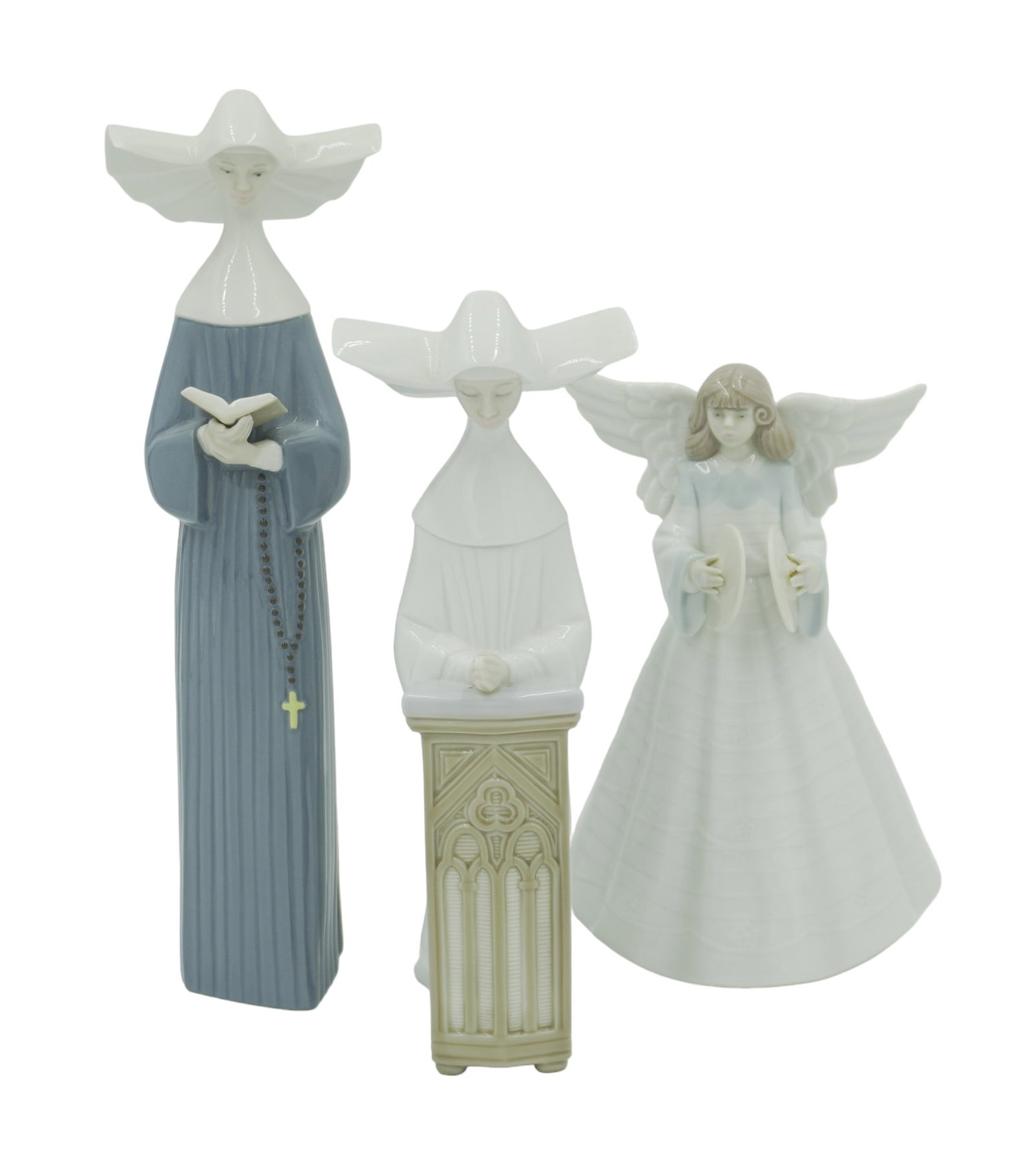 LOT OF 3 RELIGIOUS LLADRO FIGURINES: Lot of vintage Lladro. All are porcelain made in Spain and stamped on bottom. This lot includes 1) Angel with cynbals tree topper. Measures about 7.75" tall, 5" wide. 2) Praying nun in white. Measures