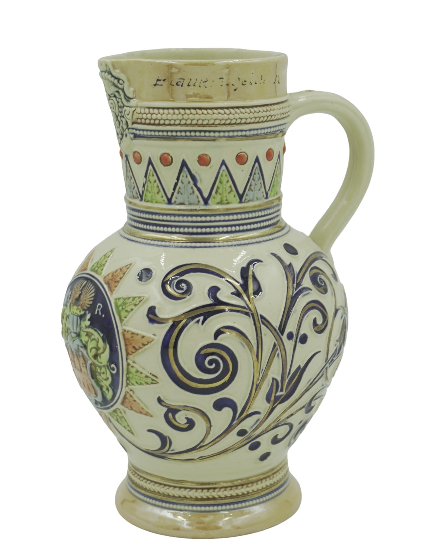 VINTAGE GERMAN MAJOLICA JUG: German Ivory Majolica Mug with multi-color decorations, gold/luster details, and a crest on the front. Signed on bottom. Measures about 9" tall, 4.75" wide, and 5" in depth (handle to spout). Total lo