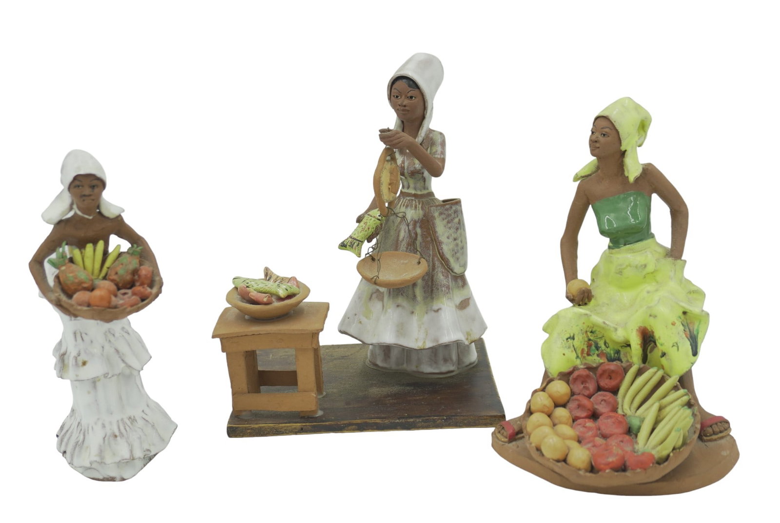 3 pc JAMAICAN RED CLAY SCULPTURES: 3 Hand Sculpted Red Clay Pottery Glazed Figures from Jamaica. Fish Seller 7.5". Seated Fruit Vendor 6.75", Standing Fruit Vendor 6.75". Hairline to 1 arm standing Fruit Vendor, Weight on all 2 lbs 3 o