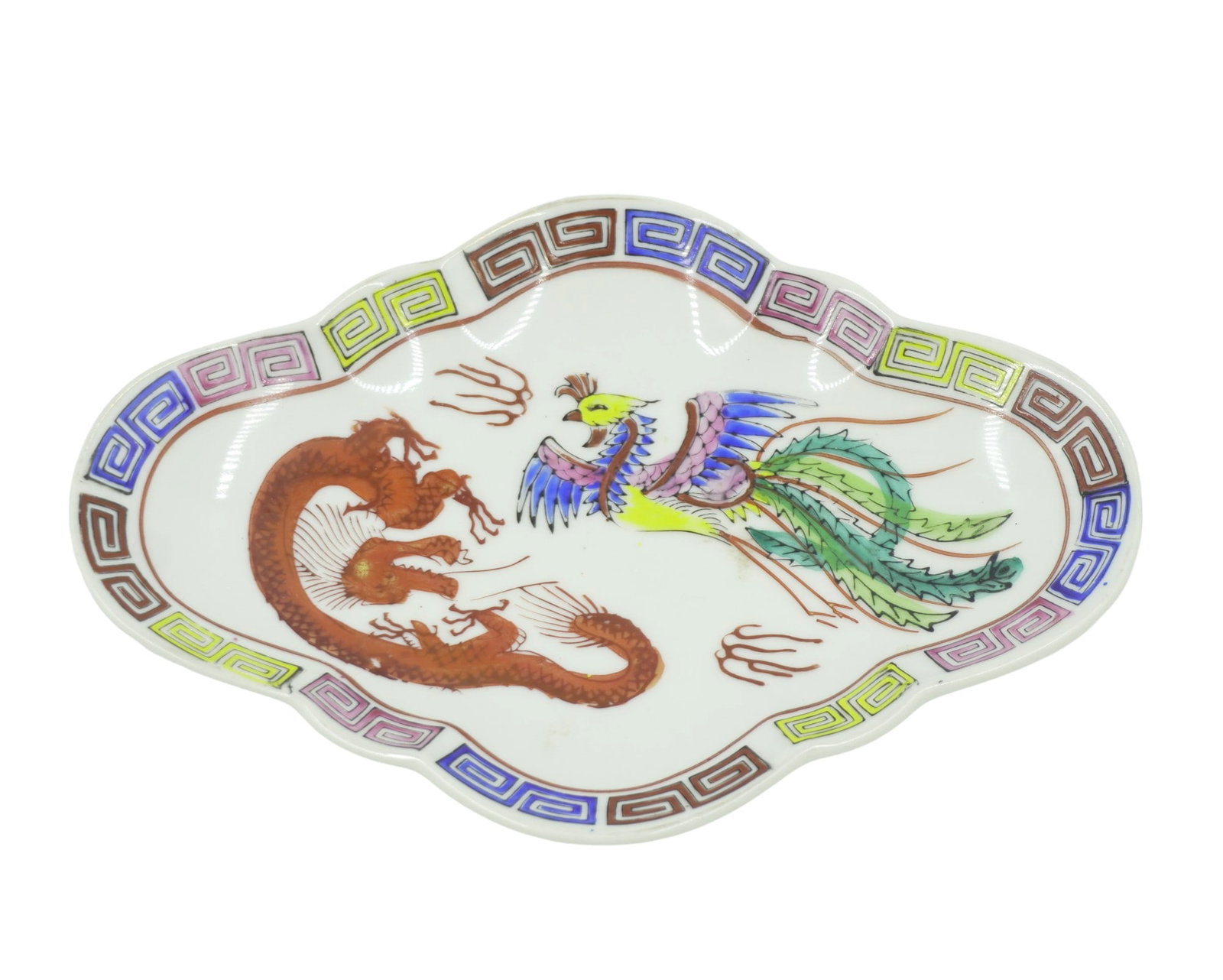 CHINESE DRAGON PHOENIX BATS FOOTED DISH: Early 20th c. Hand Painted Enameled Porcelain Chinese Export Footed Dish. The front with Phoenix and Dragon, yunwen and leiwen borders, sides with bats. Hallmarked. Measures 5"x8"x1 1/2". Weight 10 oz