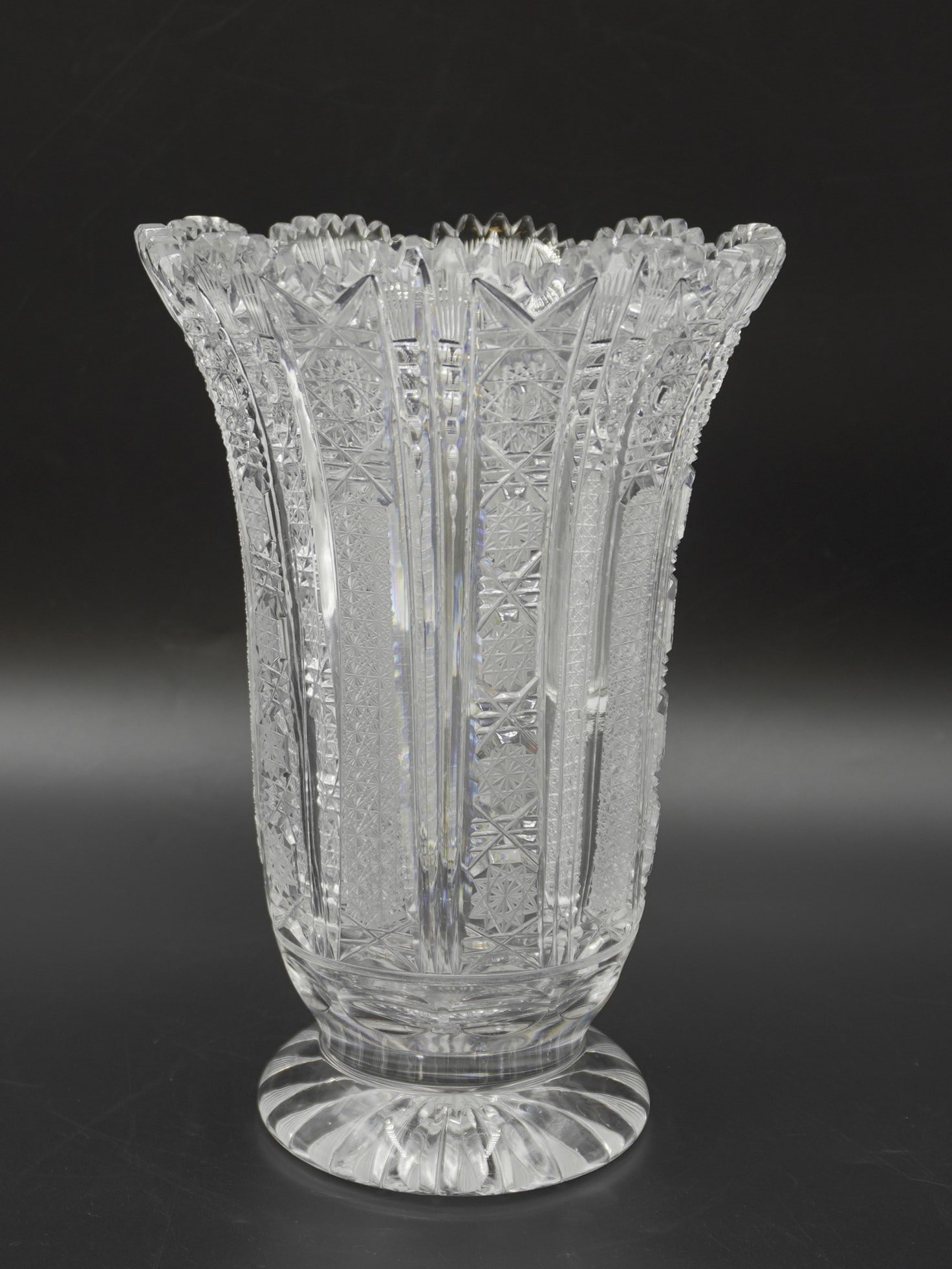 VINTAGE LARGE BOHEMIAN CZECH CUT GLASS VASE: Vintage Bohemia Czech cut glass vase in a variation of the Queen Anne's Lace pattern. Vertical panels of buzz cuts alternate with vertical panels of crosshatching. The vase is a classic form with a fl
