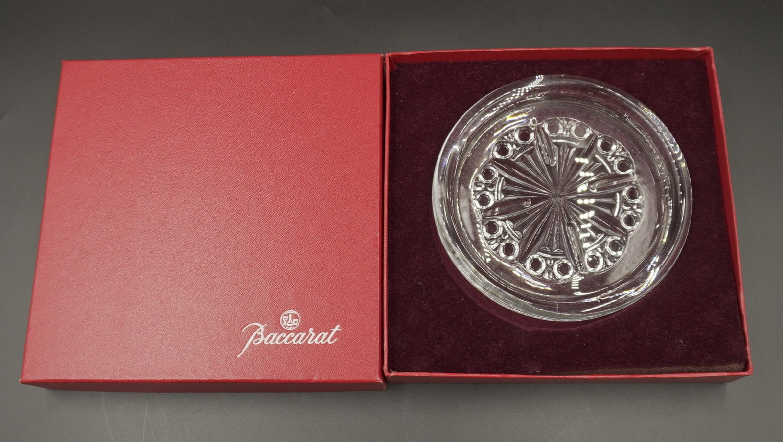 BACCARAT CRYSTAL WINE COASTER IN ORIGINAL BOX: Baccarat Crystal Wine Coaster 5.5". In the original red Baccarat box. Box 7.5"x7.5"x2". Weight 1 lb 4 oz.