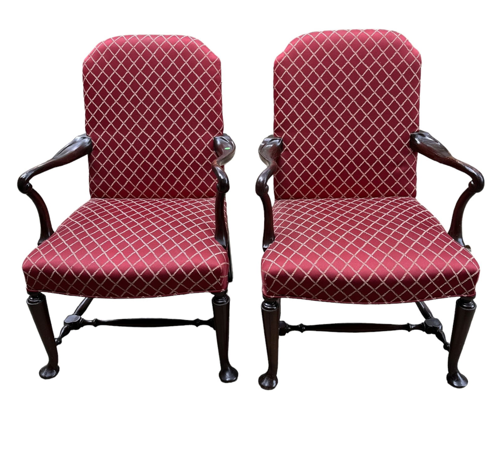 PAIR 19th c ENGLISH QUEEN ANNE ARM CHAIRS: Pair Antique Queen Anne Hump Back Arm Chairs. Scrolled arms, legs joined by stretchers, on pad feet. Upholstered in a Red Fabric with gold lozenge pattern. Each 25.5"x23"x39.5" tall.