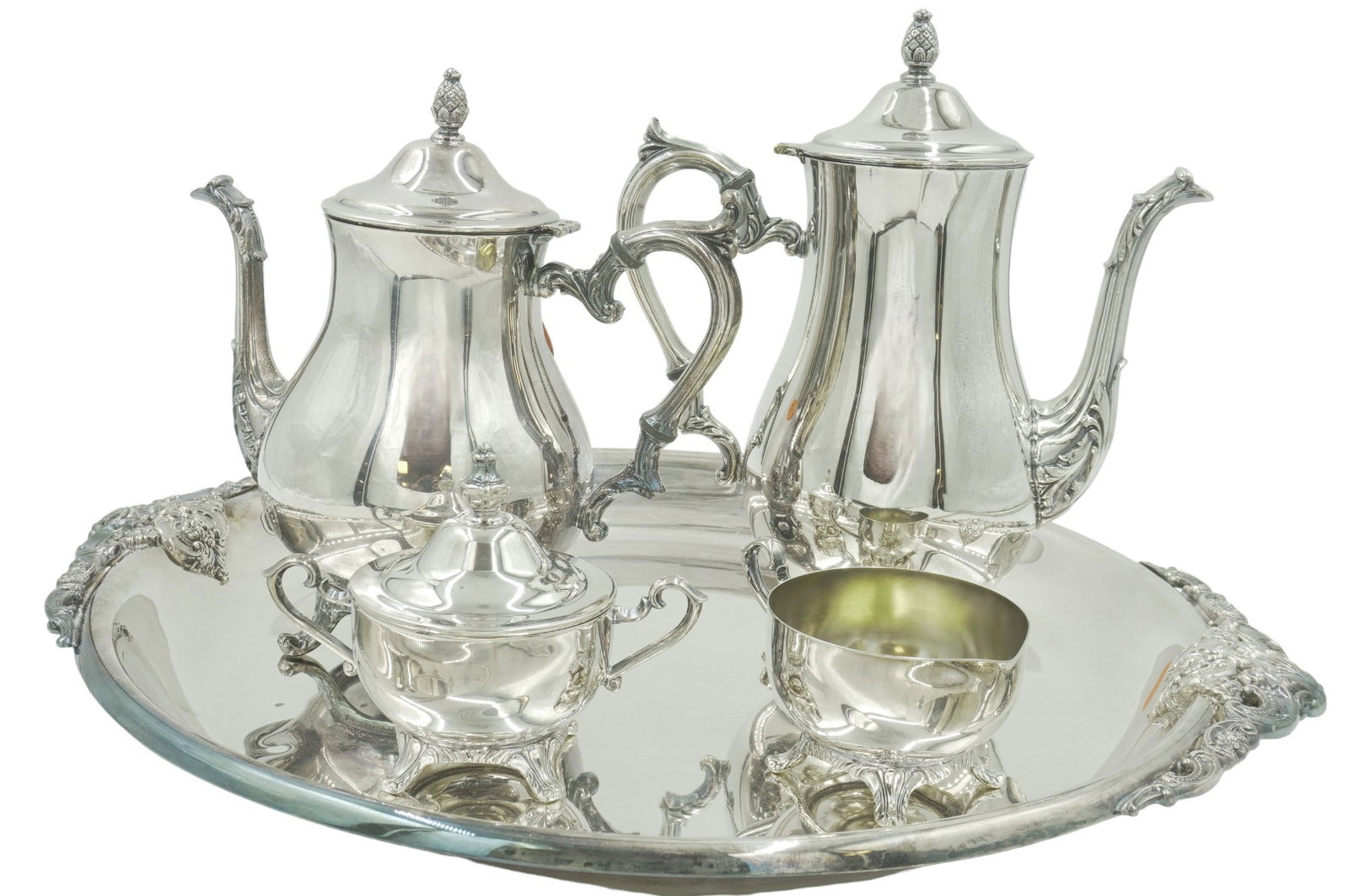 5 PC SILVER PLATE TEA SERVICE WALLACE BAROQUE plus: 5 Piece Silver Plate.. Wallace Baroque Round Tray with handles 19.5"x17"x 1.5". 4 Piece International Silver Silverplate Tea and Coffee Service. Coffee 10.5". Tea 9.5". Creamer 2.5" Covered Sugar 4.75