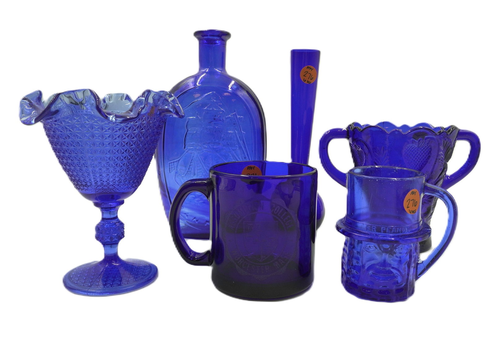 LOT OF 6 VARIOUS COBALT GLASS PIECES: Lot of 6 Various Cobalt Glass Pieces. 1) Vintage Mr.Peanut Promotional Glass Mug 2) Assumption College Mug 3) Franklin Schooner/Raised Eagle Shield 4) Bud Vase 5) Inverted Strawberry Two Handled Vase 