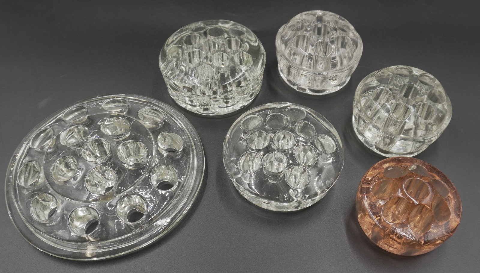 6 VINTAGE GLASS FLOWER FROGS: 6 Vintage Glass Flower Frogs. Perfect for summer arrangements. Largest with 16 Holes 5"x5". Weight on all combined 3 lbs.