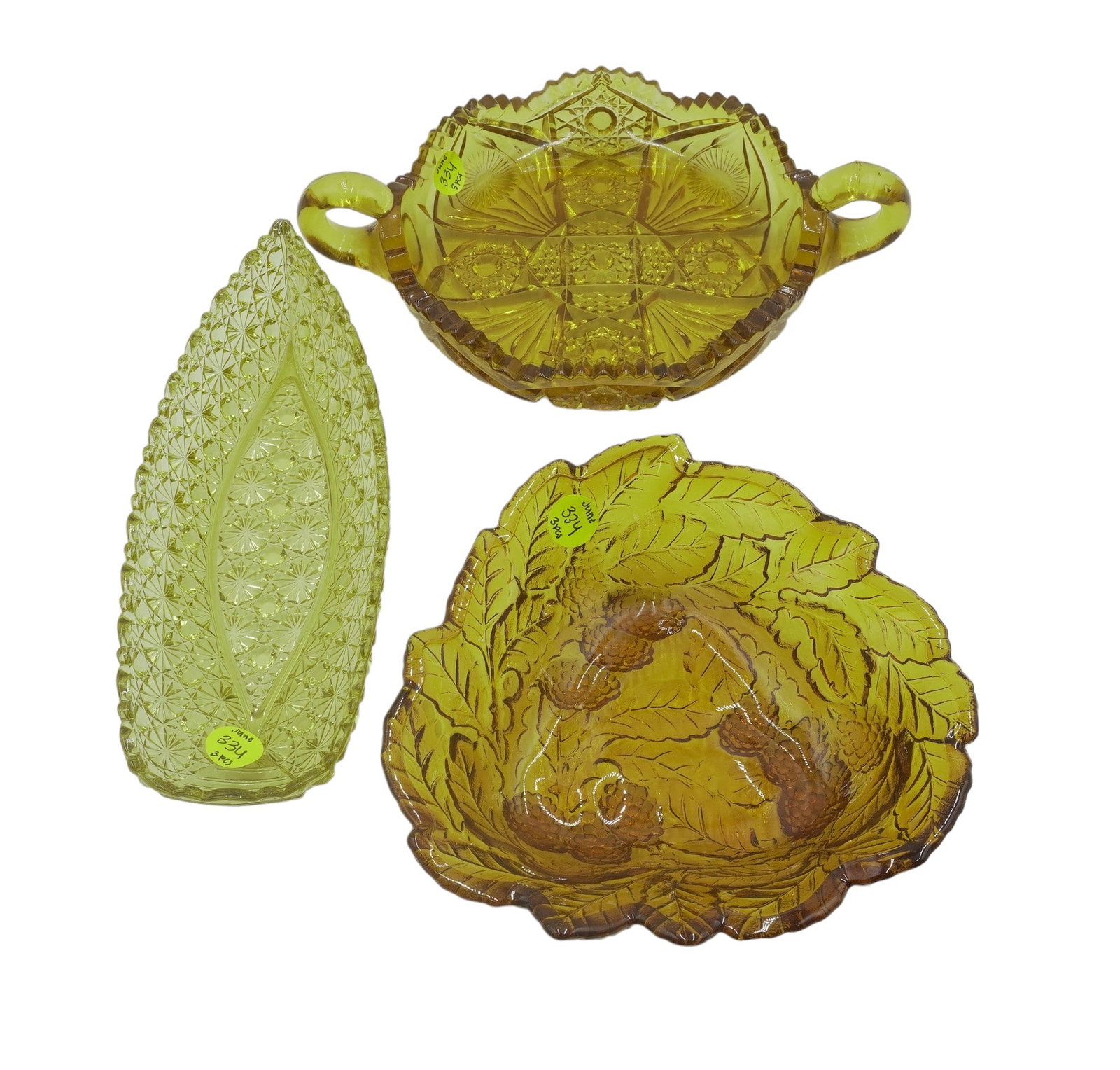 2 VINTAGE AMBER GLASS TRAYS/DISHES: 2 pieces of Vintage Amber Glass. This lot includes 1) Daisy and Button Canoe Shaped Relish Dish, measures 9.75" long, 3.75" wide, 1.5" tall. 2) Amber Glass Double Handled Candy Dish, measures 2.75" ta
