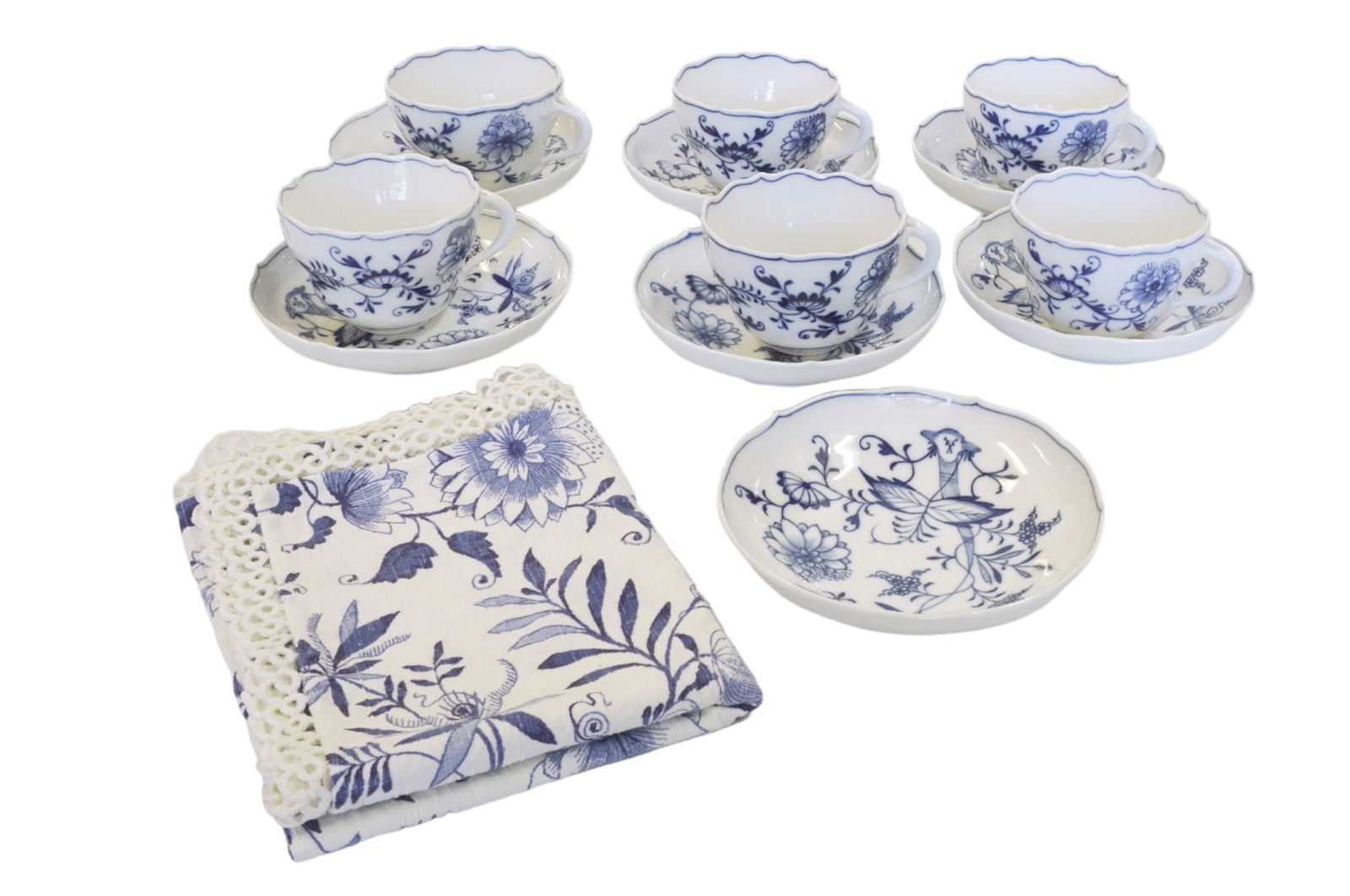 ANTIQUE MEISSEN BLUE ONION TEA CUPS AND SAUCERS - 13 PIECES: Antique Meissen Blue Onion Teacups and Saucers. This lot includes 6 teacups and 7 saucers, circa early 1800s. Also includes matching dish towel. Teacups measure 3.25" in dia and 2.5" in height, saucer