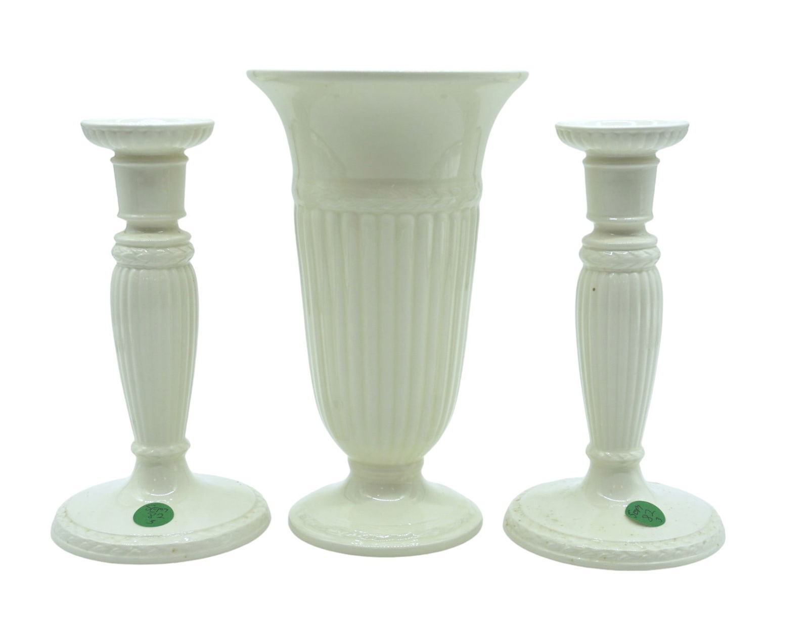3 WEDGWOOD EDME VASE + CANDLESTICKS: Wedgwood of Etruria & Barlaston "Edme" vase, in tall gloss cream white and a pair of Candlesticks. . Vase measures 5" wide and 9" tall and candlesticks are 4.25"x8".Both feature vertical ridges, foote