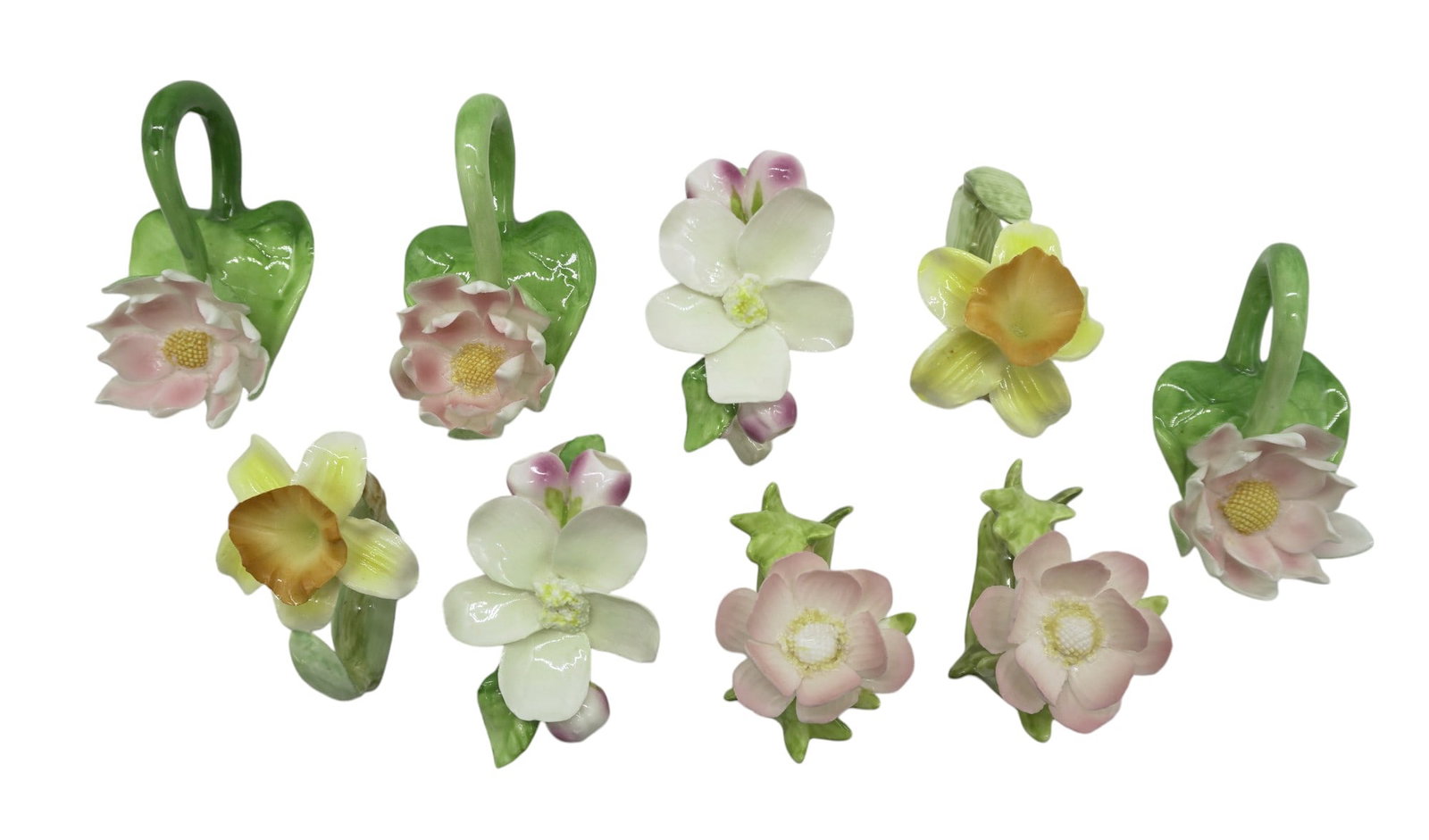 11 FINE BONE CHINA NAPKIN FLORAL RINGS: 11 Fine Bone China Napkin Rings. 2 Iris, 2 Pink Lotus, 2 Yellow Daffodil, 3 Dogwood, 2 Pink Floral. Excellent Condition. All are nicely sized. Iris 3"x2"x4". Weight on all combined 3 lbs 2 oz.