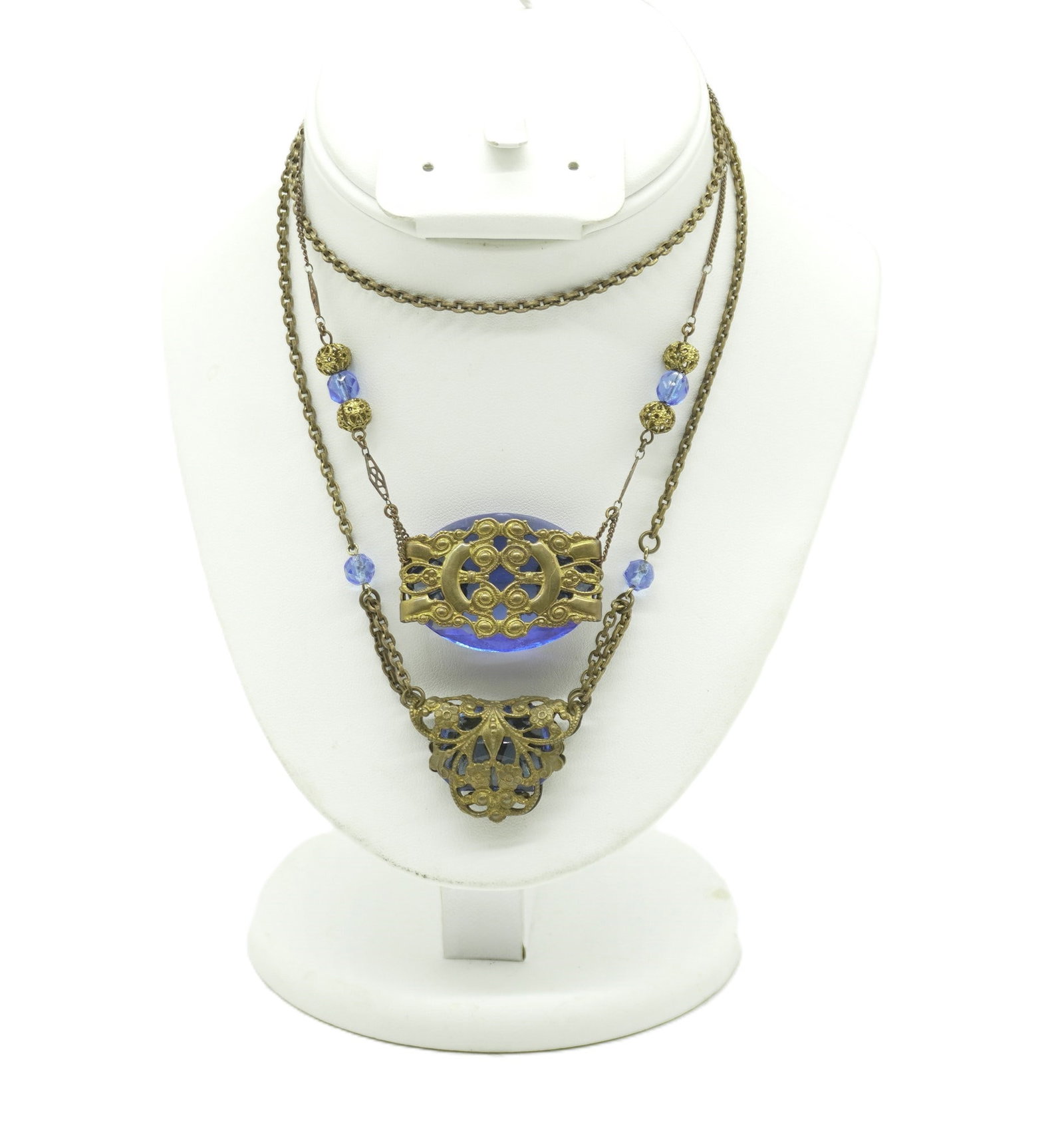 2 ART NOUVEAU ORNATE GILT BLUE CZECH GLASS NECKLACES: Both are Antique Art Nouveau Blue Glass with Brass Gilt Filigree Necklaces. 1- Faceted Blue Czech Glass with pierced and blue glass beads. Center 1 3/4". Length 8". 2- Filigree Pierced Wrapped Faceted