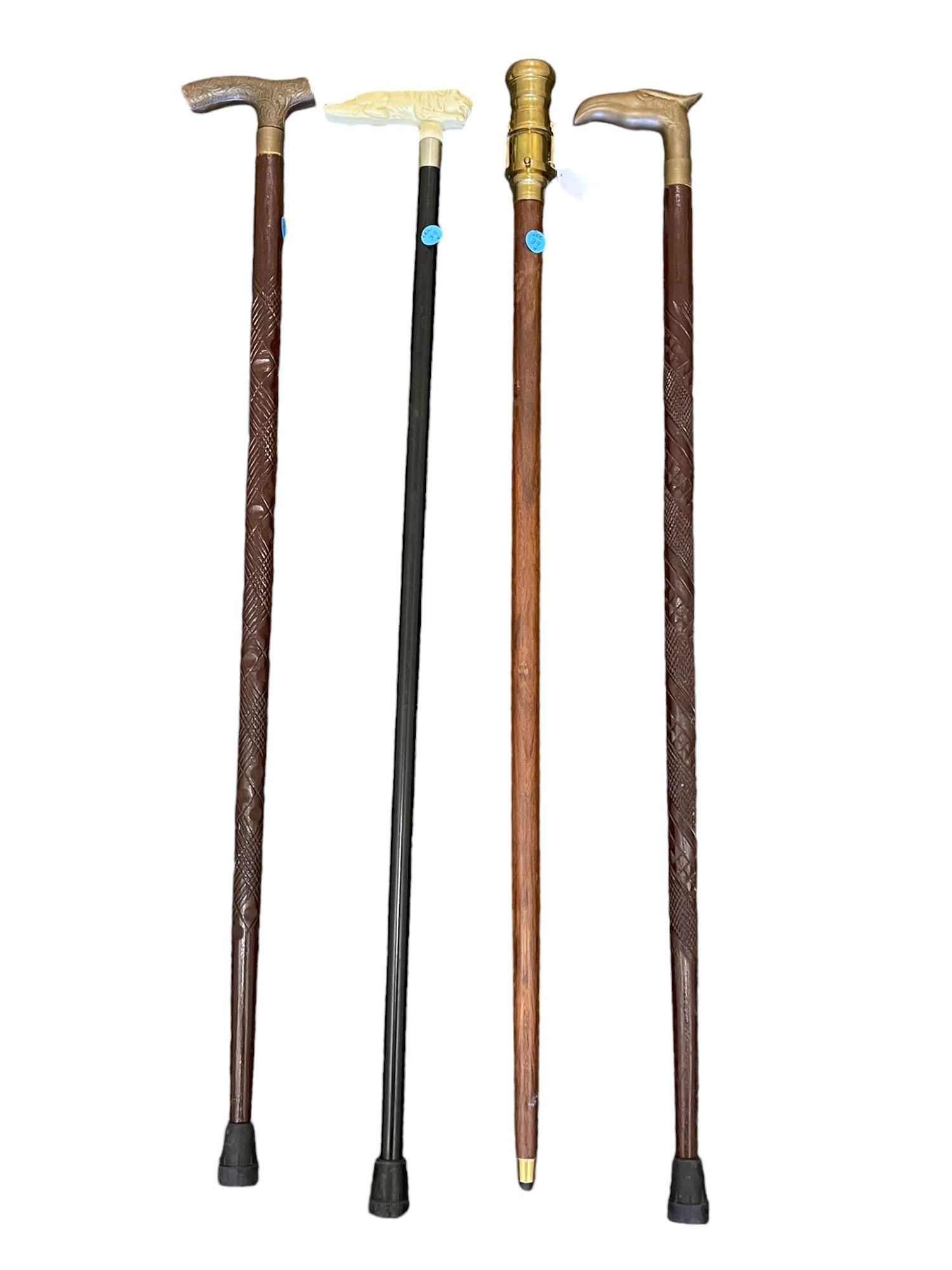 4 VINTAGE CANES / WALKING STICKS: 1- Brass Telescope Cane Netherlands 36.5". 2- Brass Eagle Head Top Carved Cane 36.5" 3- Carved Tiger with Glass eyes Ebony Cane 37'. 4- Brass Top Carved Wood Cane 36.5". Weight on all 6 lbs,