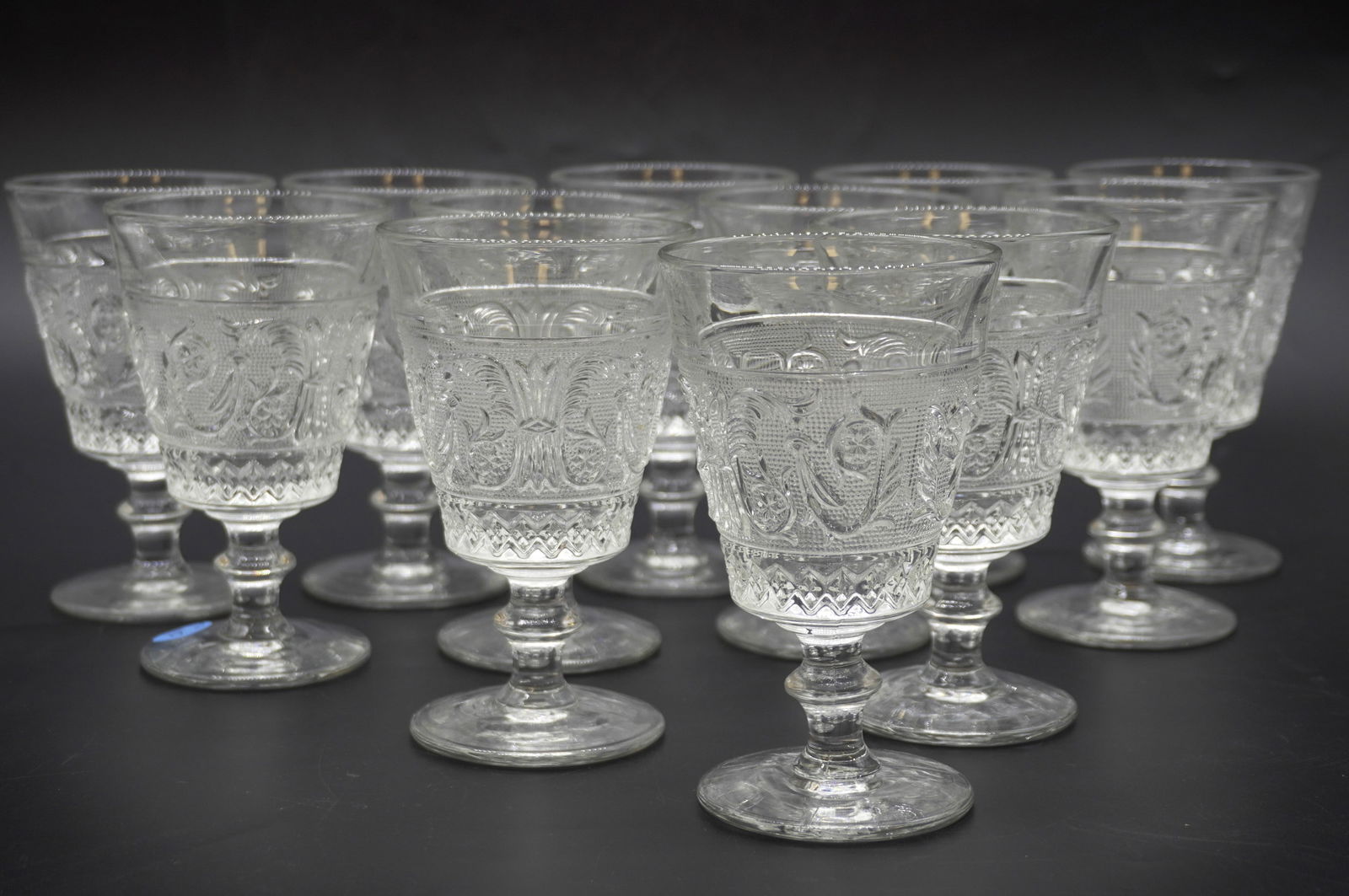 12 ANTIQUE DUNCAN & MILLER SANDWICH GLASS WATER GOBLETS: Antique / Vintage Duncan and Miller Sandwich Glass Water Goblets Stem #41, circa 1930s. 12 pieces total. Each measures 5 5/8 in x 3 1/2 in. Total lot weight is 10 lbs.