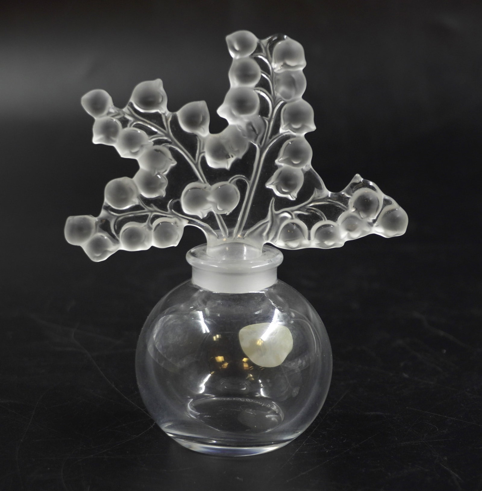 LALIQUE CRYSTAL CLAIREFONTAINE PERFUME: Lalique Crystal France Clairfontaine Perfume and Stopper. 4 Sprigs of Lily of the Valley. Signed. Measures 4 3/4". Weight 6 oz. PROVENANCE: Part of a large Charleston collection of Lalique Crystal we 