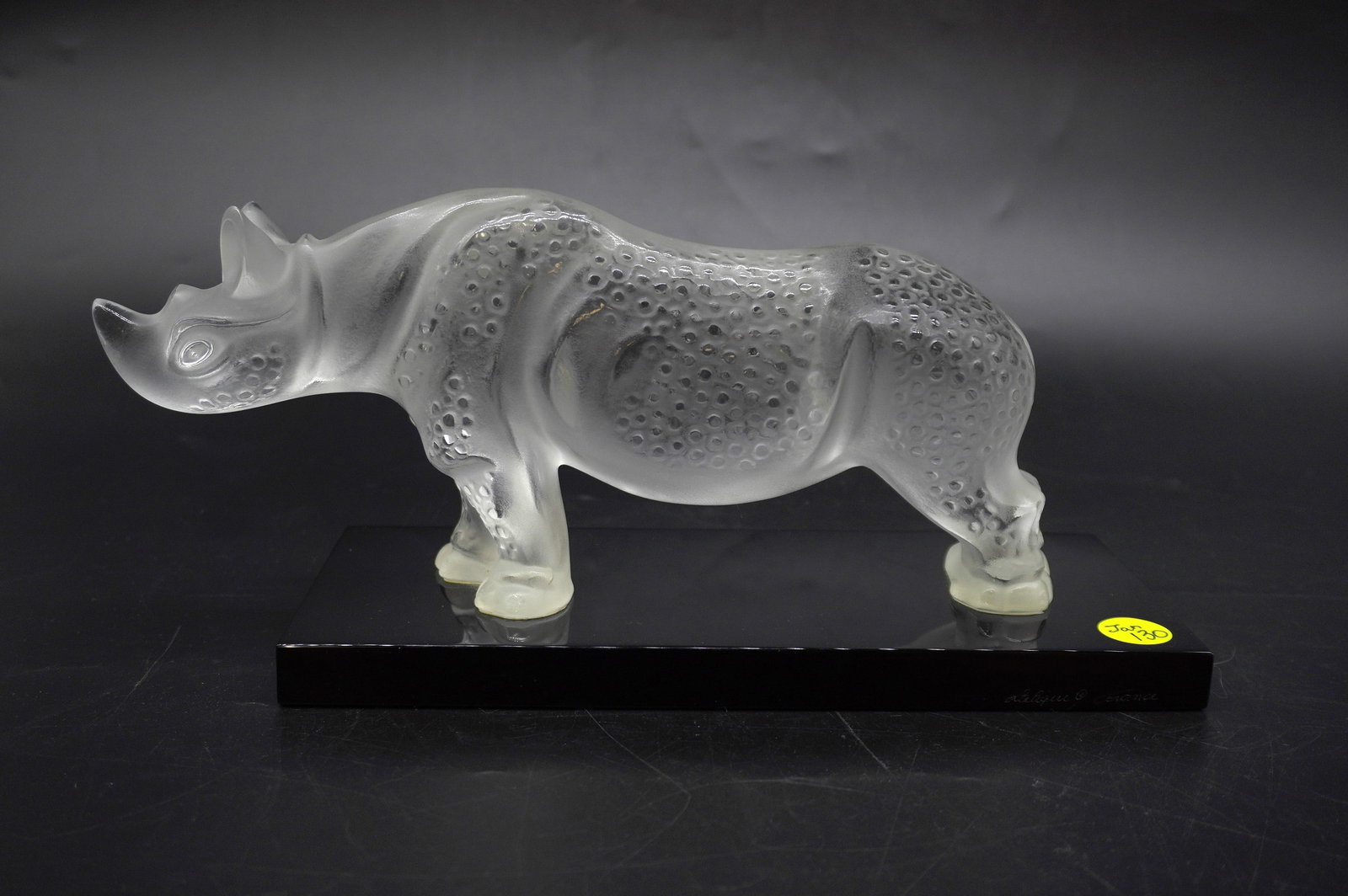 LARGE LALIQUE CRYSTAL RHINOCEROS ON BASE: Large Lalique Crystal France Rhinoceros on Black Glass Base. Signed. Measures 11.5"x4"x5.25". Weight 7 lbs PROVENANCE: Part of a large Charleston collection of Lalique Crystal we will be auctioning.