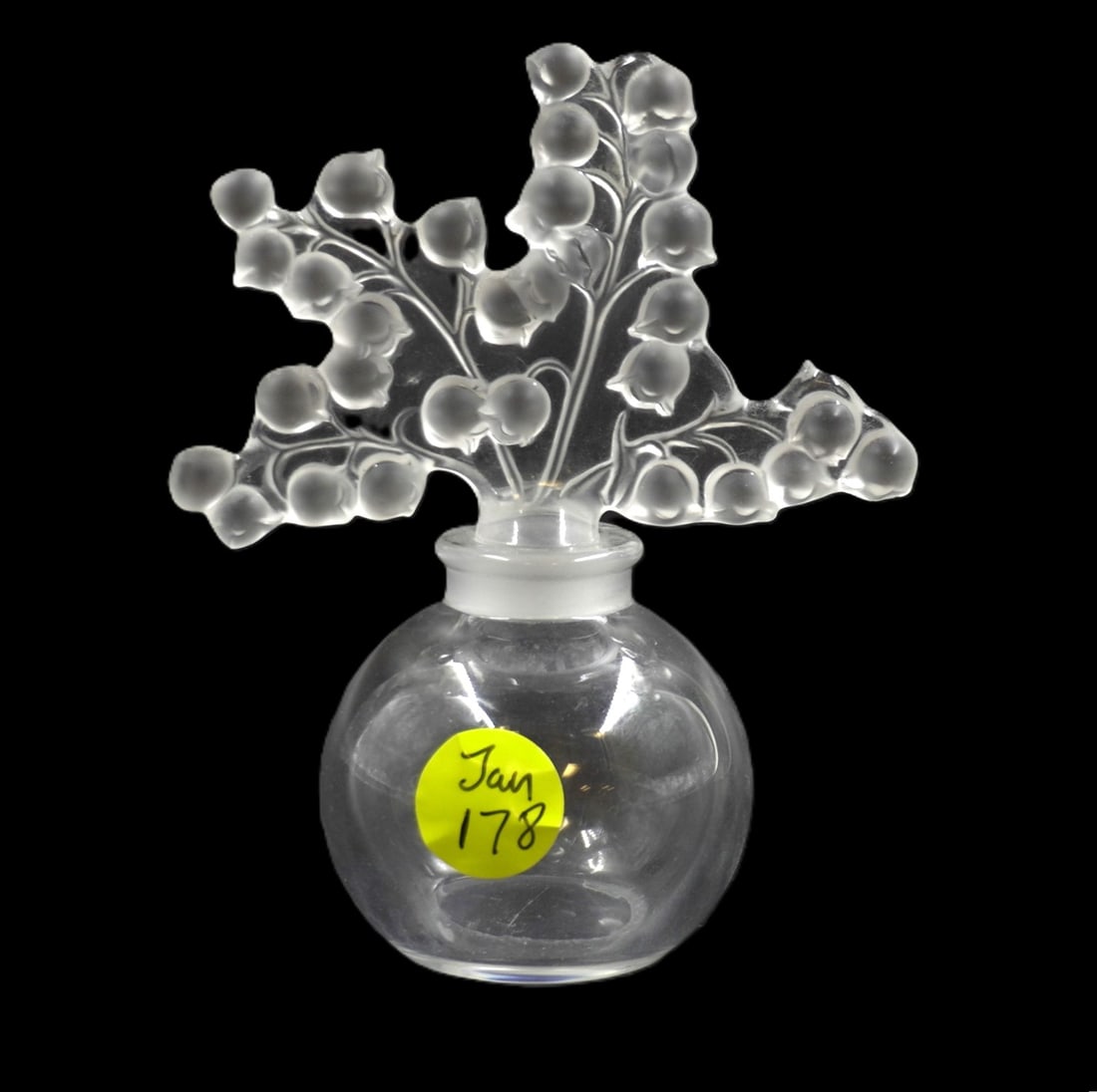 LALIQUE CRYSTAL CLAIREFONTAINE PERFUME: Lalique Crystal France Clairfontaine Perfume and Stopper. 4 Sprigs of Lily of the Valley. Signed. Measures 4 3/4". Weight 6 oz. PROVENANCE: Part of a large Charleston collection of Lalique Crystal we 