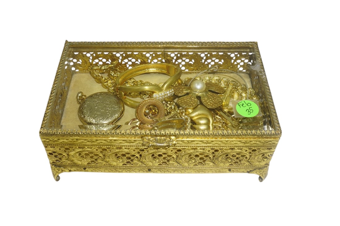 MCM GILDED FILIGREE JEWELRY CASKET WITH JEWELRY: Vintage Gilded Filigree Jewelry Casket with Beveled Glass Top. With 12 Piece Vintage Gold Tone Costume Jewelry. All earrings are clip ons. Box Measures 8"x5"x3". Weight 2 lbs 7 oz