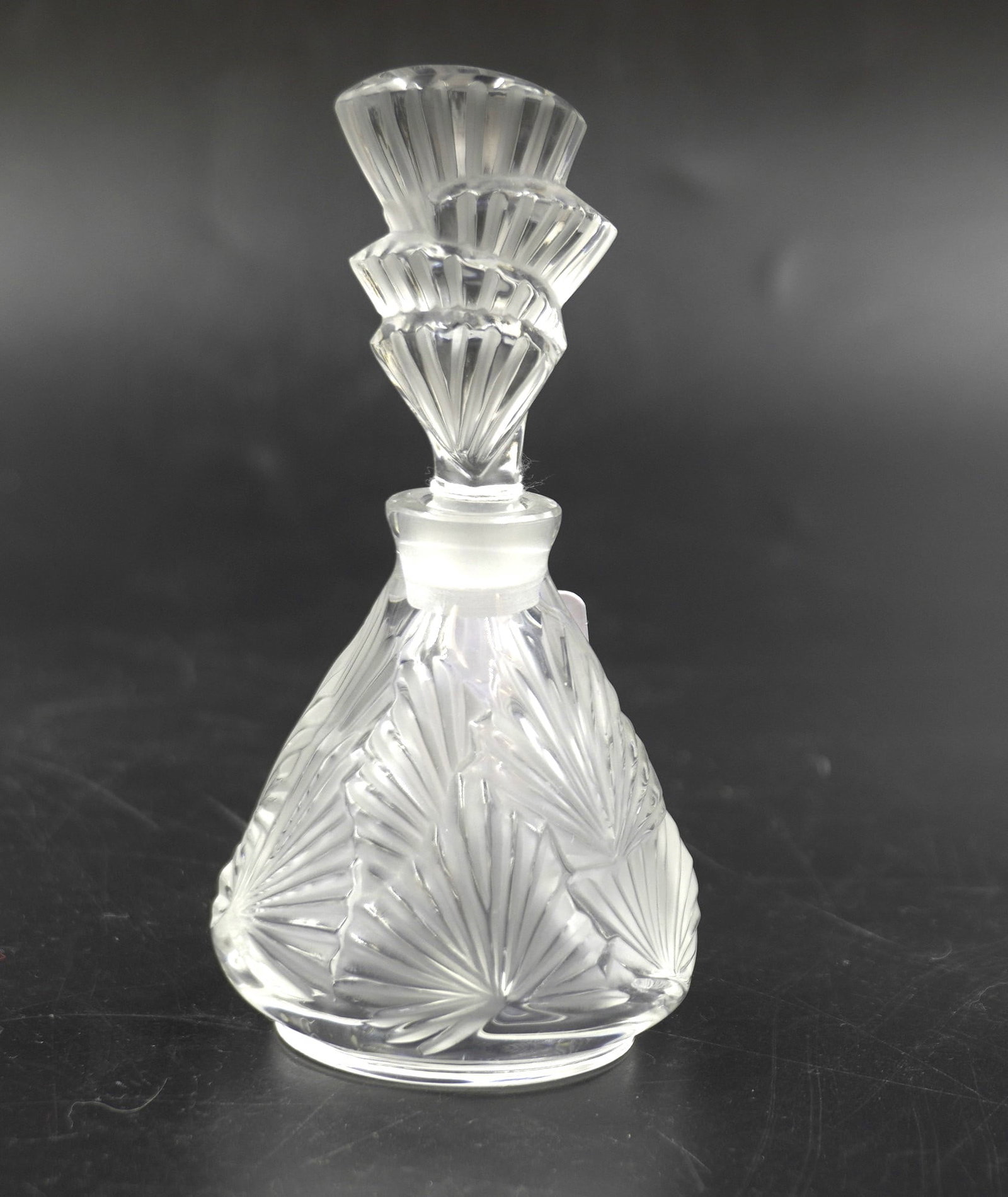 LALIQUE CRYSTAL PALMETTE PERFUME AND STOPPER: Lalique Crystal France Palmette Perfume and Stopper. Signed. Measures 2.1/2"x2 1/2"x5". Weight 7 oz. PROVENANCE: Part of a large Charleston collection of Lalique Crystal we will be auctioning.