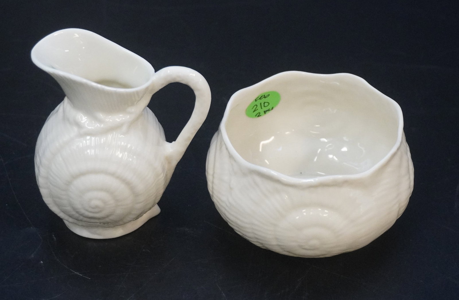 BELLEEK IRELAND PORCELAIN SUGAR AND CREAMER: Belleek Ireland Porcelain Sugar and Creamer. Creamer measures 4" x 3" x 2.5" and sugar measures 2.25" x 3.5", total lot weight is 5.3 oz.