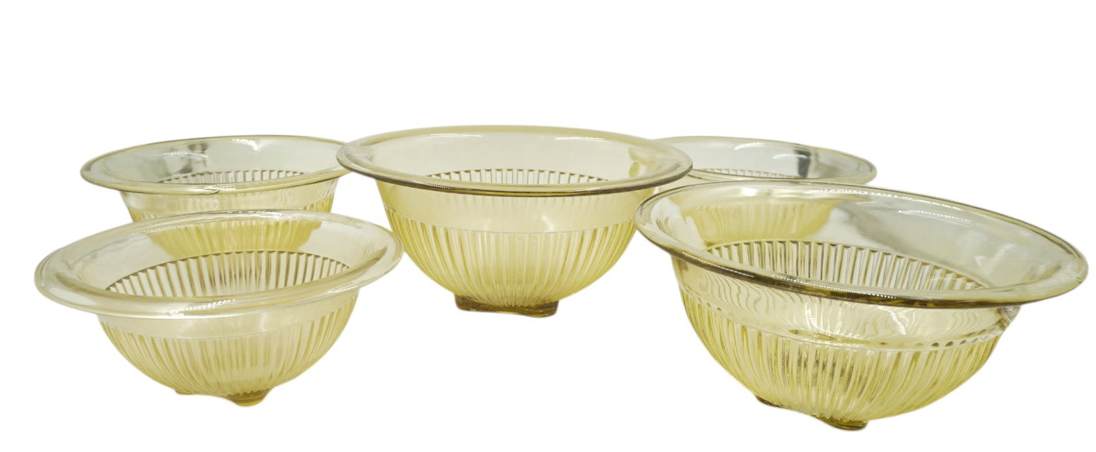 5 FEDERAL GLASS AMBER YELLOW RIBBED NESTING BOWLS: 5 Federal Glass Amber/Yellow Ribbed Nesting Bowls. Largest bowl measures 5.25" x 12" dia. Total lot weight is 10 lbs 15 oz.