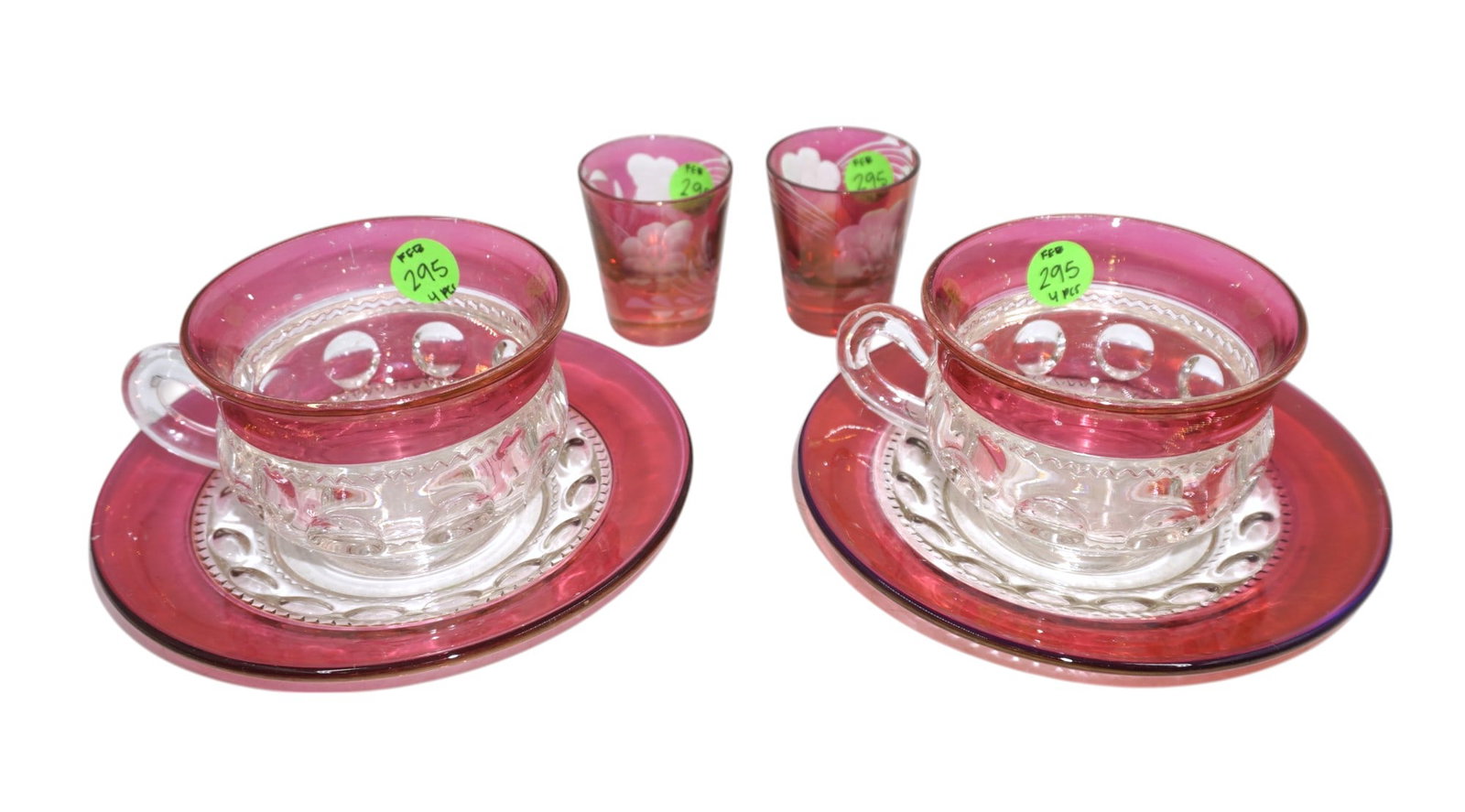 LOT OF VINTAGE CRANBERRY GLASS - 4 PIECES: This lot includes 1) 2 Cranberry Glass Shot Glasses, each measures about 2.25" x 2" 2) 2 Ruby Crown Teacups by Colony with Saucers. Cups measure 2.5" x 4.5" x 3.5" and saucers are 6" in dia. Total lot
