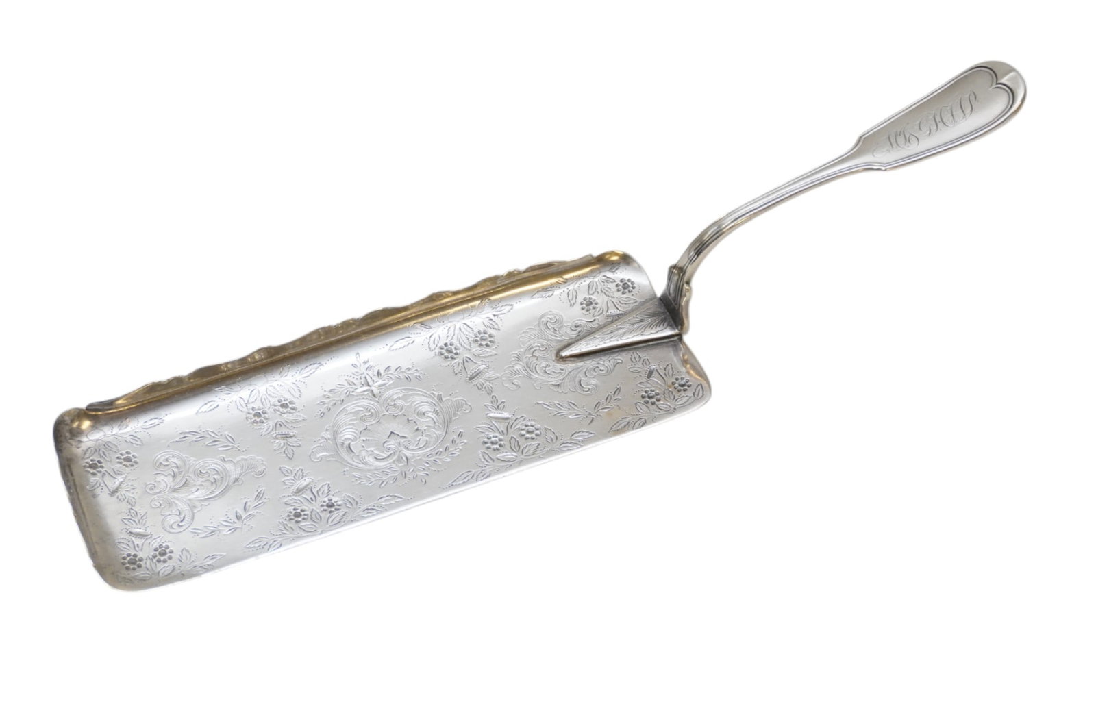 CHARLESTON CARRINGTON COIN SILVER ORNATE CRUMBER: Charleston, William Carrington Coin Silver Crumber. South Carolina, late 19th century, ornate chased, scroll, and floral decoration. Measures 12.75". Approximate Silver weight 186 grams. William Carri