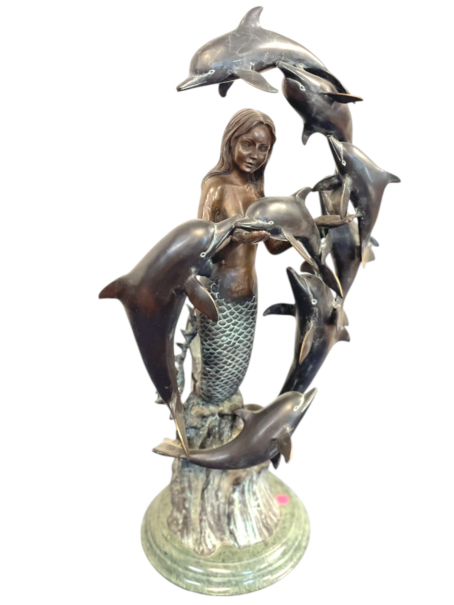 BRONZE MERMAID AND DOLPHINS ON MARBLE BASE 29": Contemporary Patinated Bronze Sculpture of a Mermaid and Dolphins, the mermaid resting her tail on an ocean wave with multiple dolphins circling. Green marble base. Measures 12"x16"x24". Weight 36 lbs