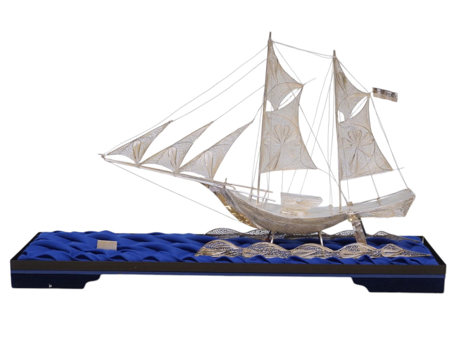 SILVER MASTED CUTTER FILIGREE SHIP IN DISPLAY CASE: Silver Masted Cutter Filigree Ship in Glass Display Case. Measures 16" x 13" x 3.5" and weighs 6 lbs 5 oz.