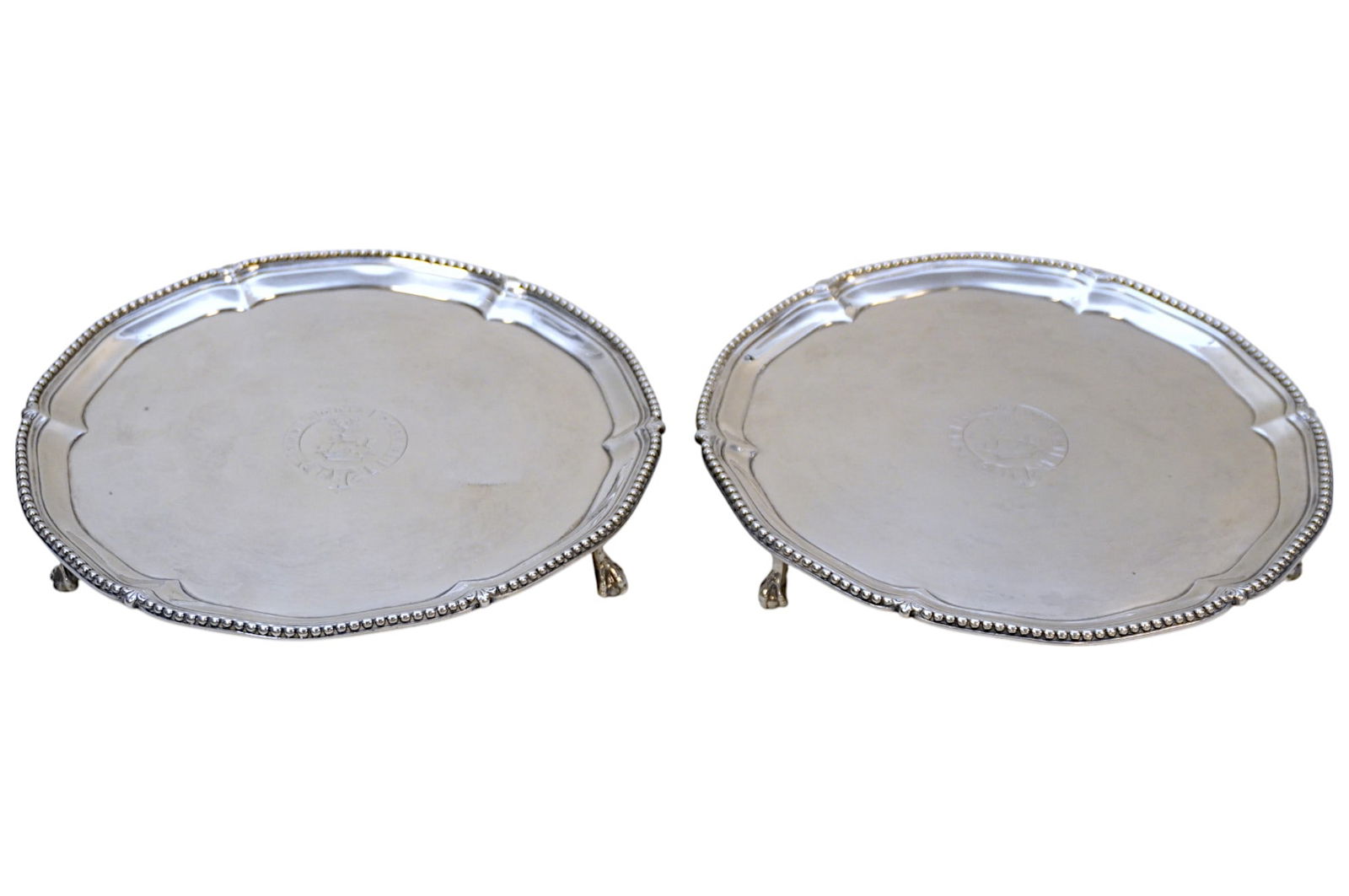 2 18TH C ENGLISH STERLING FOOTED TRAYS: Matched pair of Sterling Silver Antique 18th c .Salvers / Card Trays.by Robert Makepeace & Richard Carter, London. c 1778. Ball and claw feet, beaded rims and central engraved crest. Each 7 1/8"x1". A