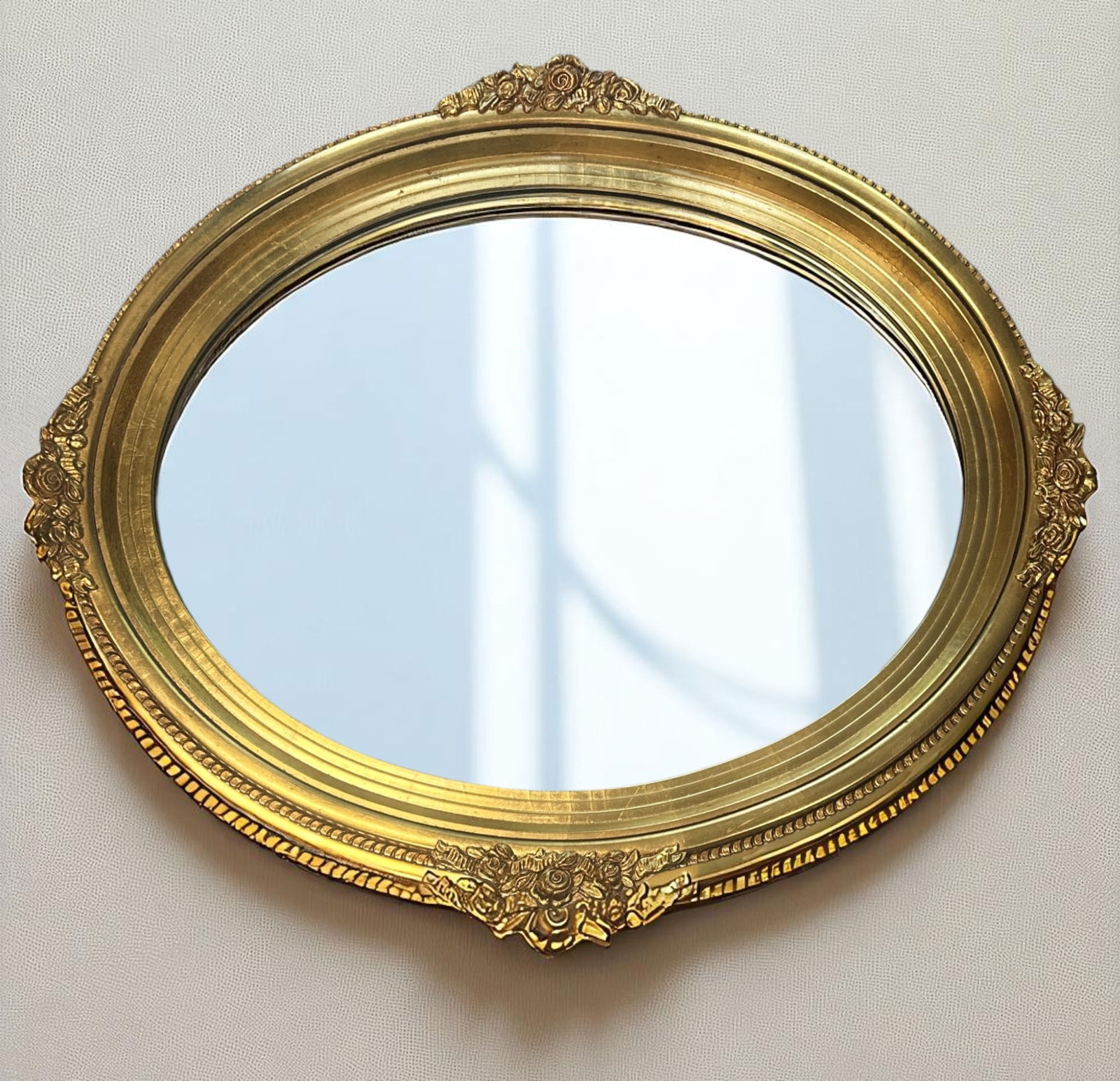 VINTAGE GILT OVAL MIRROR FLORAL SWAGS: Vintage Gilt Oval Mirror, beaded edge, floral swags. Measures 35"x29.5"x2". Weight approx 6 lbs