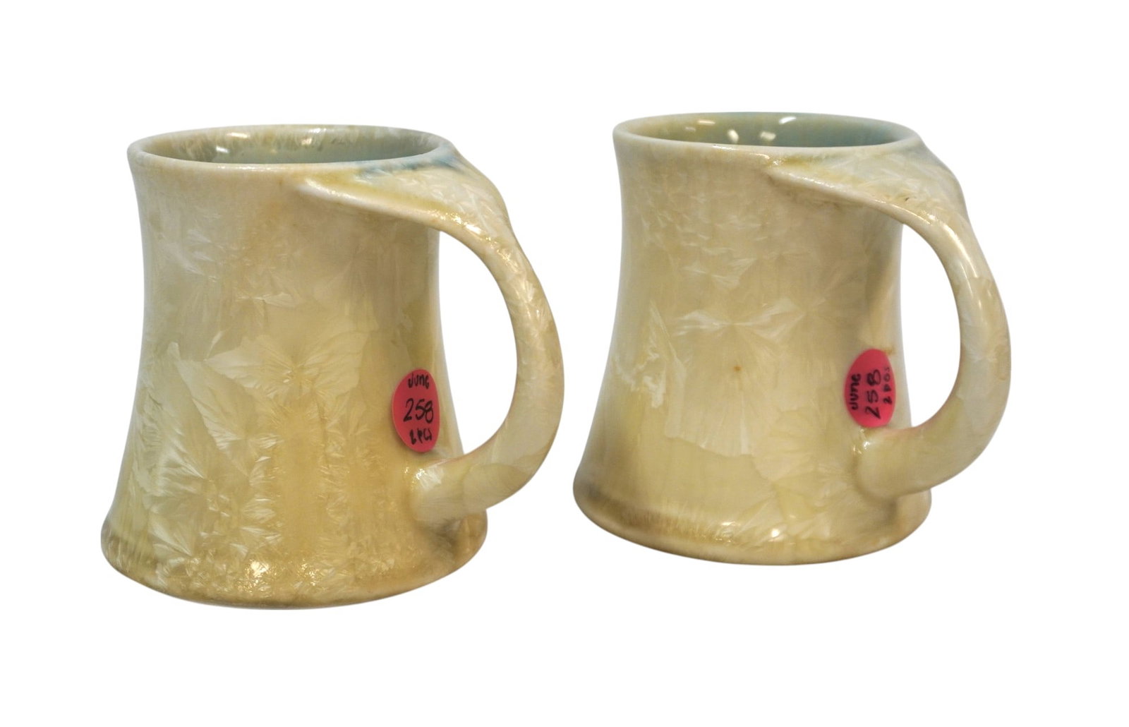 PAIR OF EDGECOMB POTTERS HANDMADE MUGS: Pair of Edgecomb Potters Handmade Whale Tale Mugs with "Mother of Pearl" finish. Each measures 3.75" x 4" x 3.5", total lot weight is 1 lb 13 oz.
